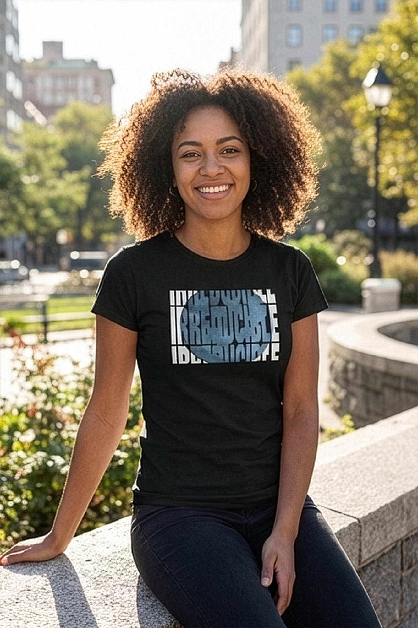 Female model wearing black t-shirt of fragmented block typography for a bold, architectural lookg