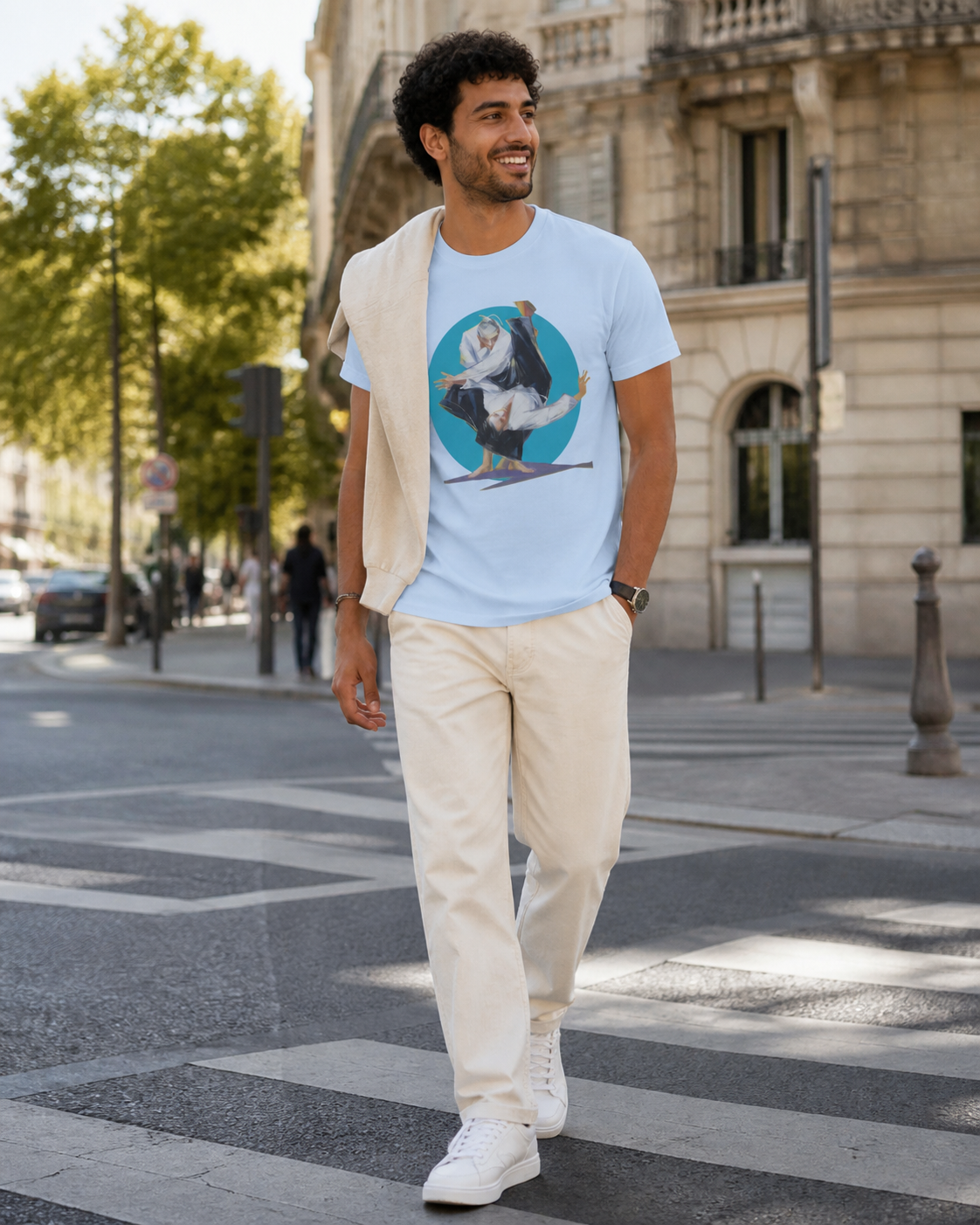 Male model wearing figurative martial art image framed by a bold circular backdrop on light blue t-shirt