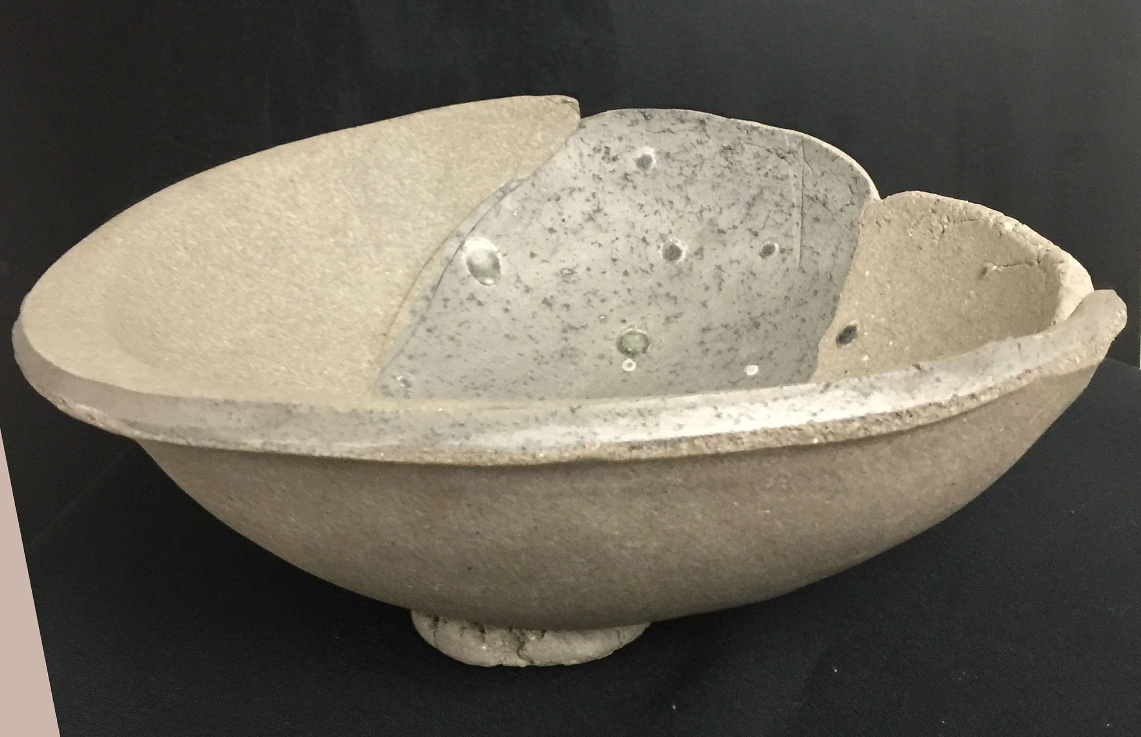 Large yakishime unglazed stoneware bowl with organic ash textures and softly irregular rim, displayed under gallery lighting