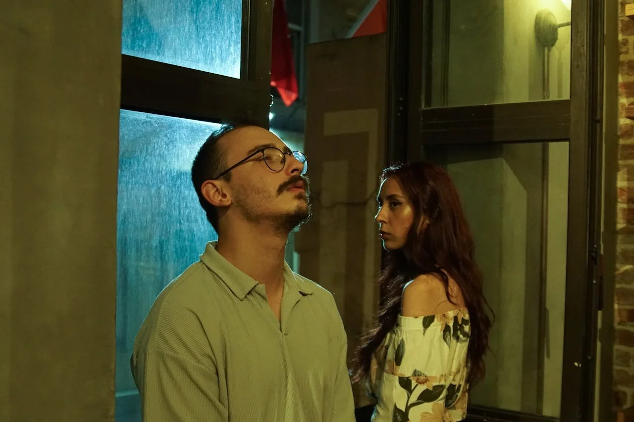 man-and-woman-standing-in-front-of-a-window