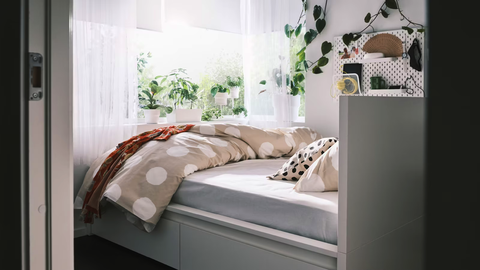 a-malm-bed-facing-a-large-sunny-window-with-lush-plants-on-t-81052fffb69810be24b2e43d3c8f3b2f.png