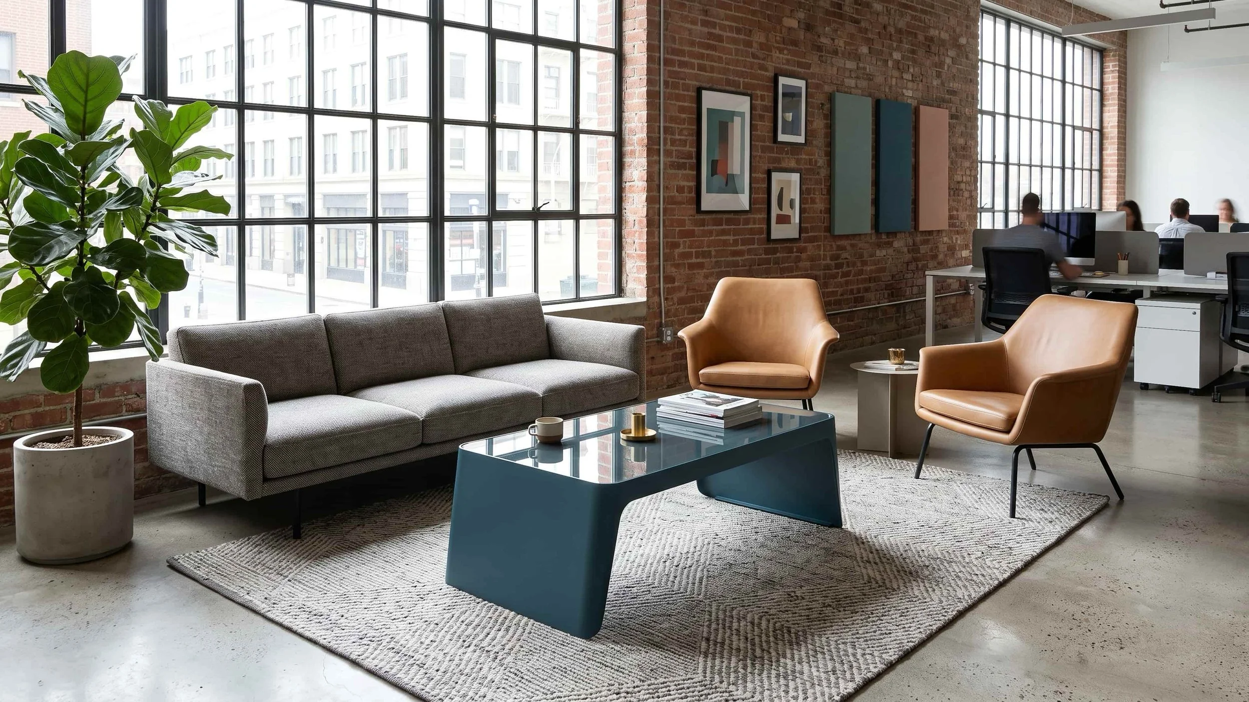 A Span coffee table in slate blue forms part of a communal space in a busy office.