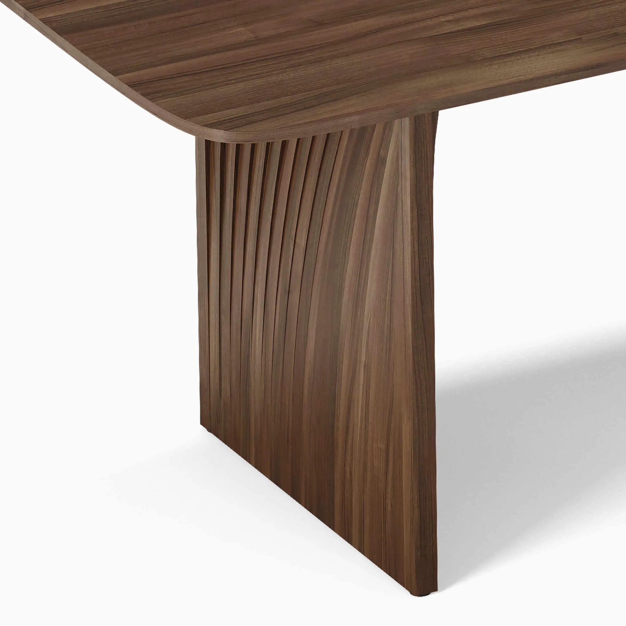 Detail view of the base of a Sheer dining table in Walnut. The layers of wood offer a novel aesthetic that reference sedimentary rocks.