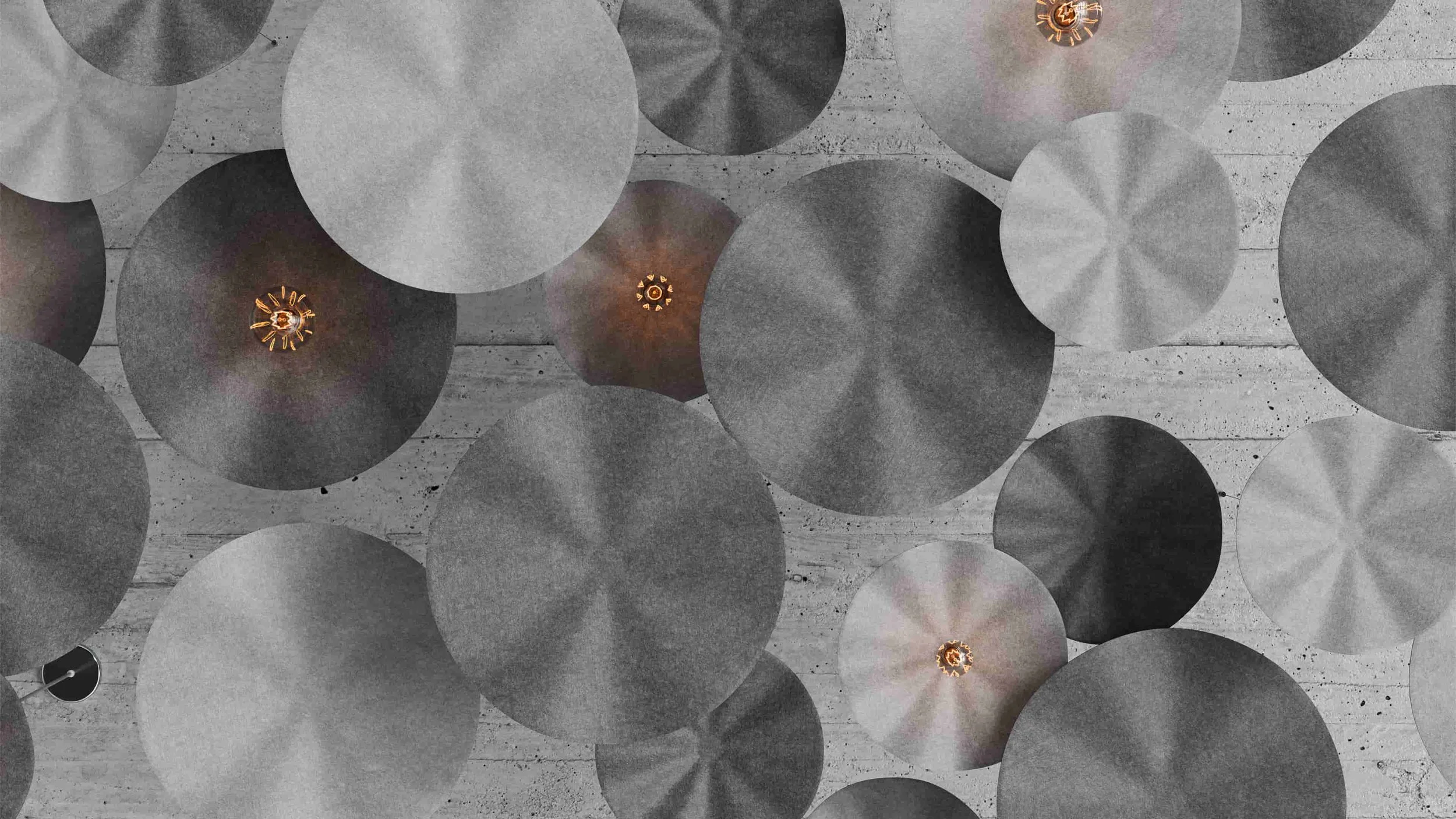 A worm's eye view of a random arrangement of Flutter suspension panels and pendant lights blanketing an entire ceiling.