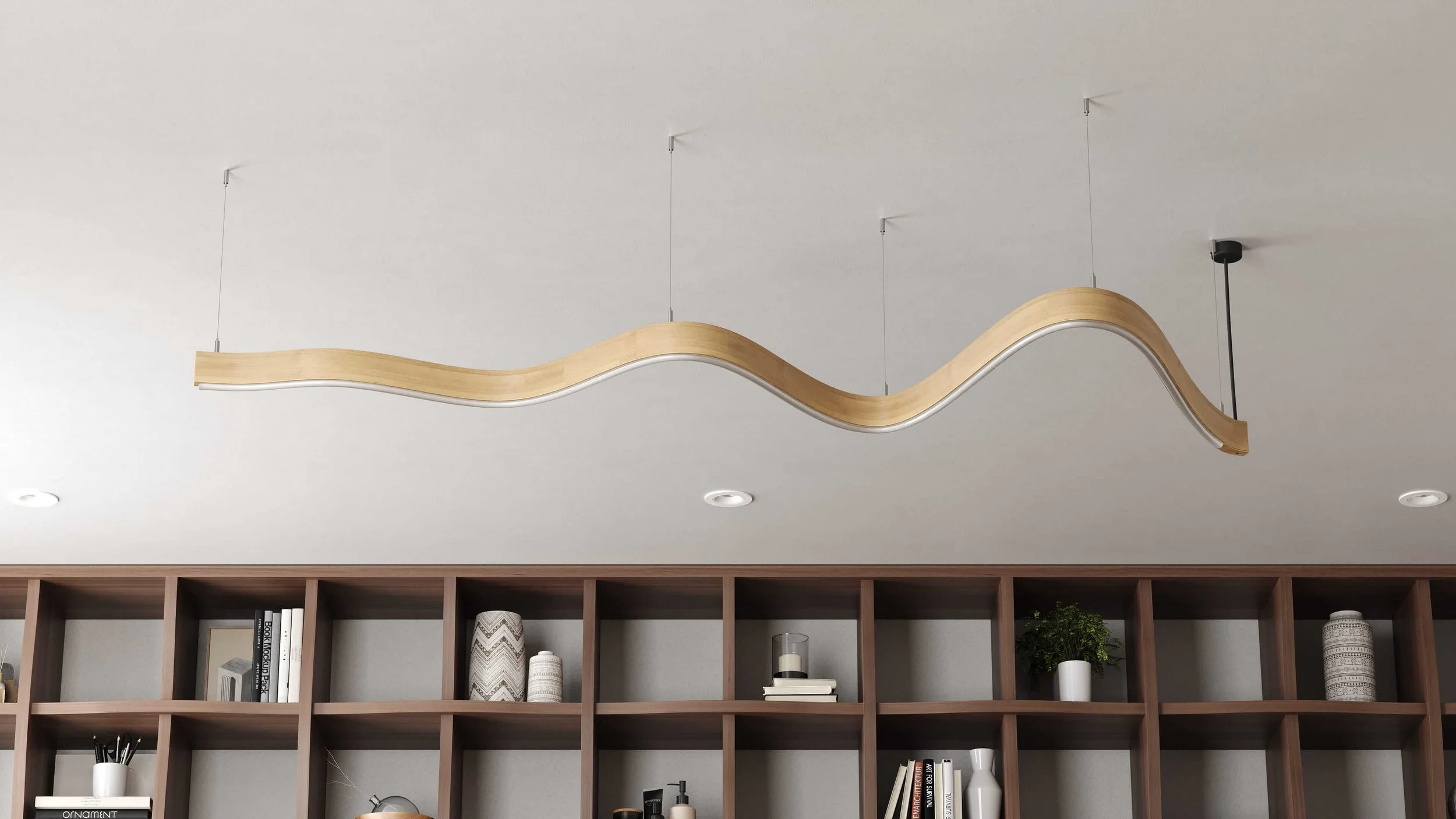 A Scribble suspension light in Oak, hung in a residential interior. It's free-flowing form makes a strong graphic statement.