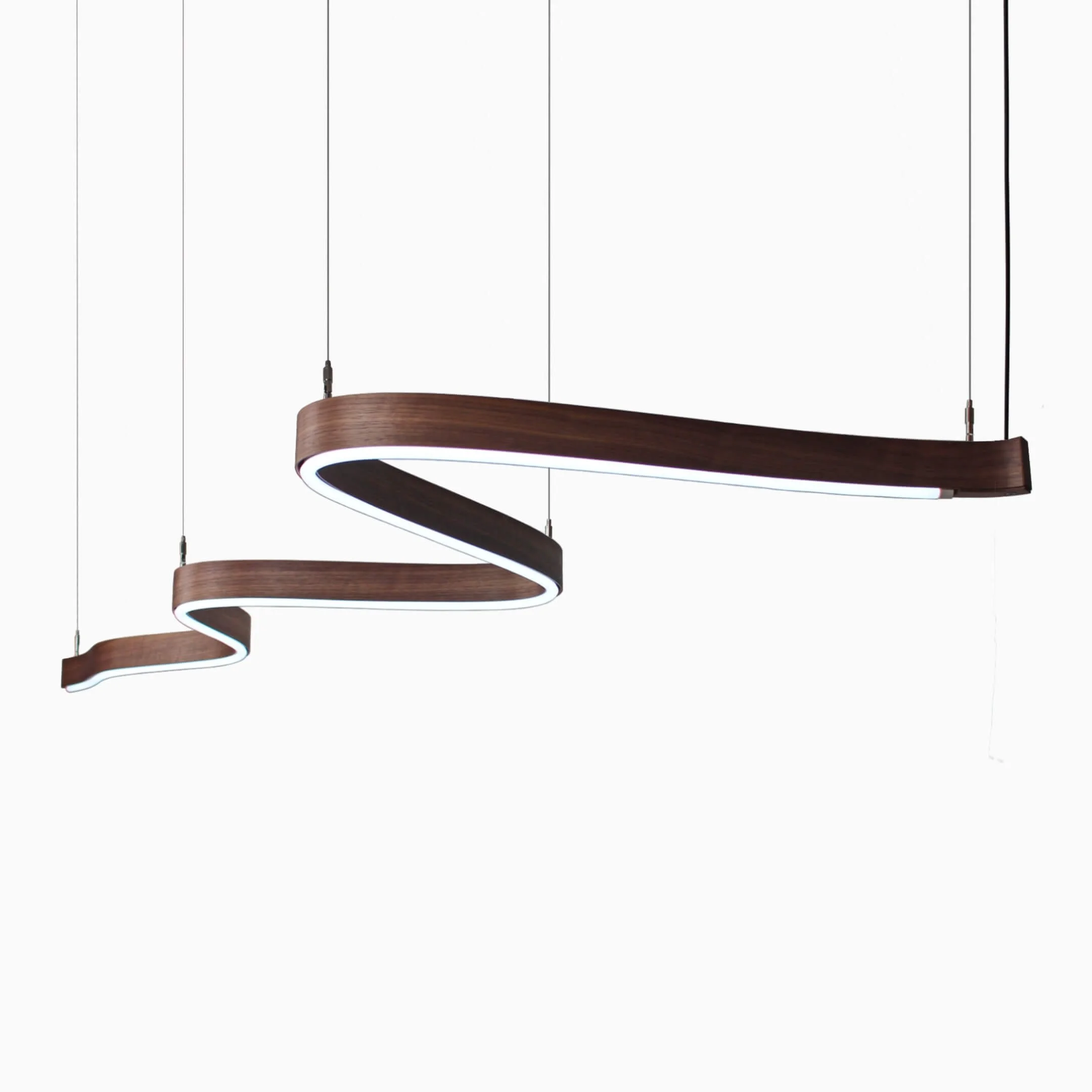 A Scribble suspension light with an American Black Walnut body and a cool white light source.