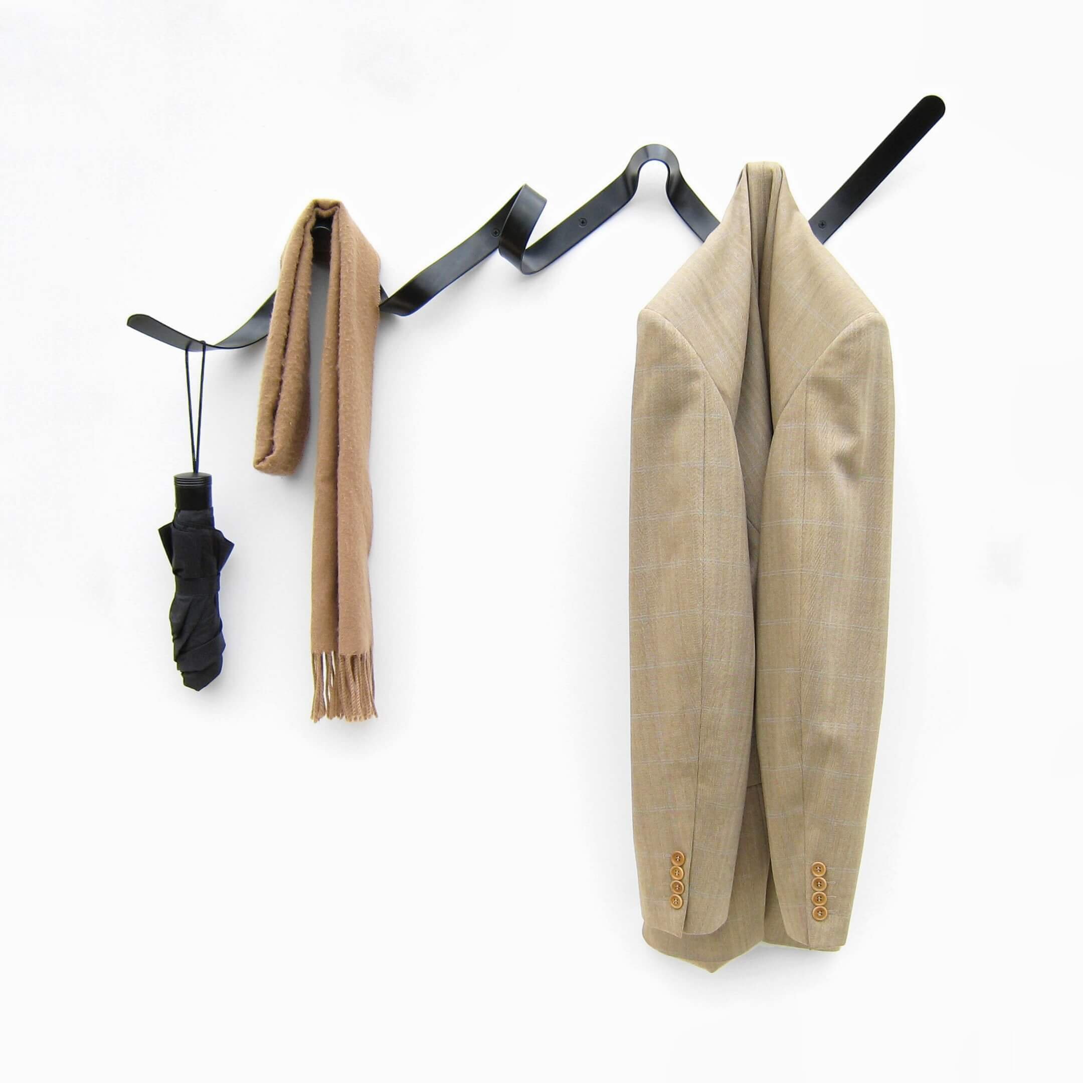 Front view of a black Ribbon coat rack. Its unique design marries art and function, offering families a practical, yet stylish, everyday storage solution.