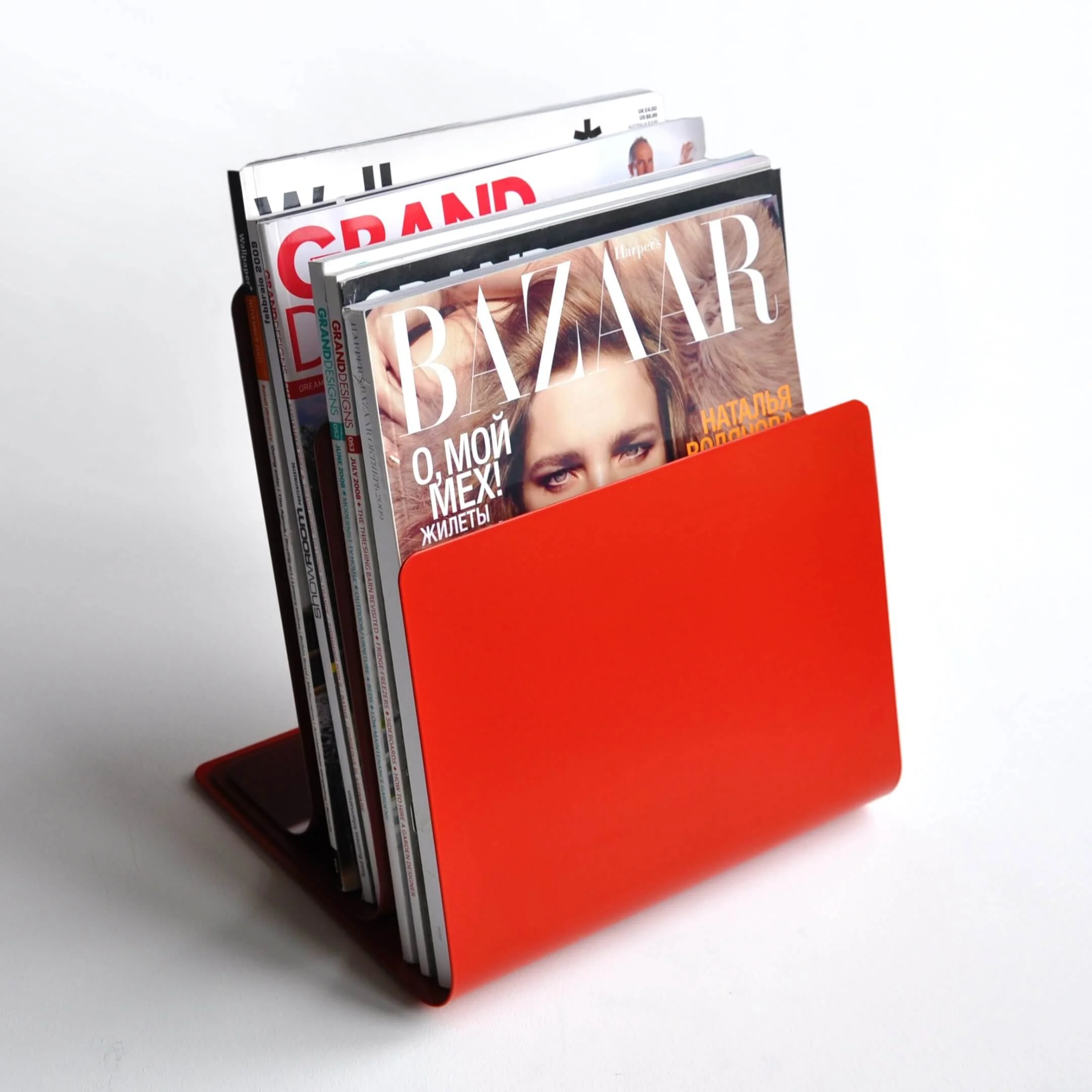 The compact, space-saving Strata magazine rack holding a number of magazine publications on a desktop.
