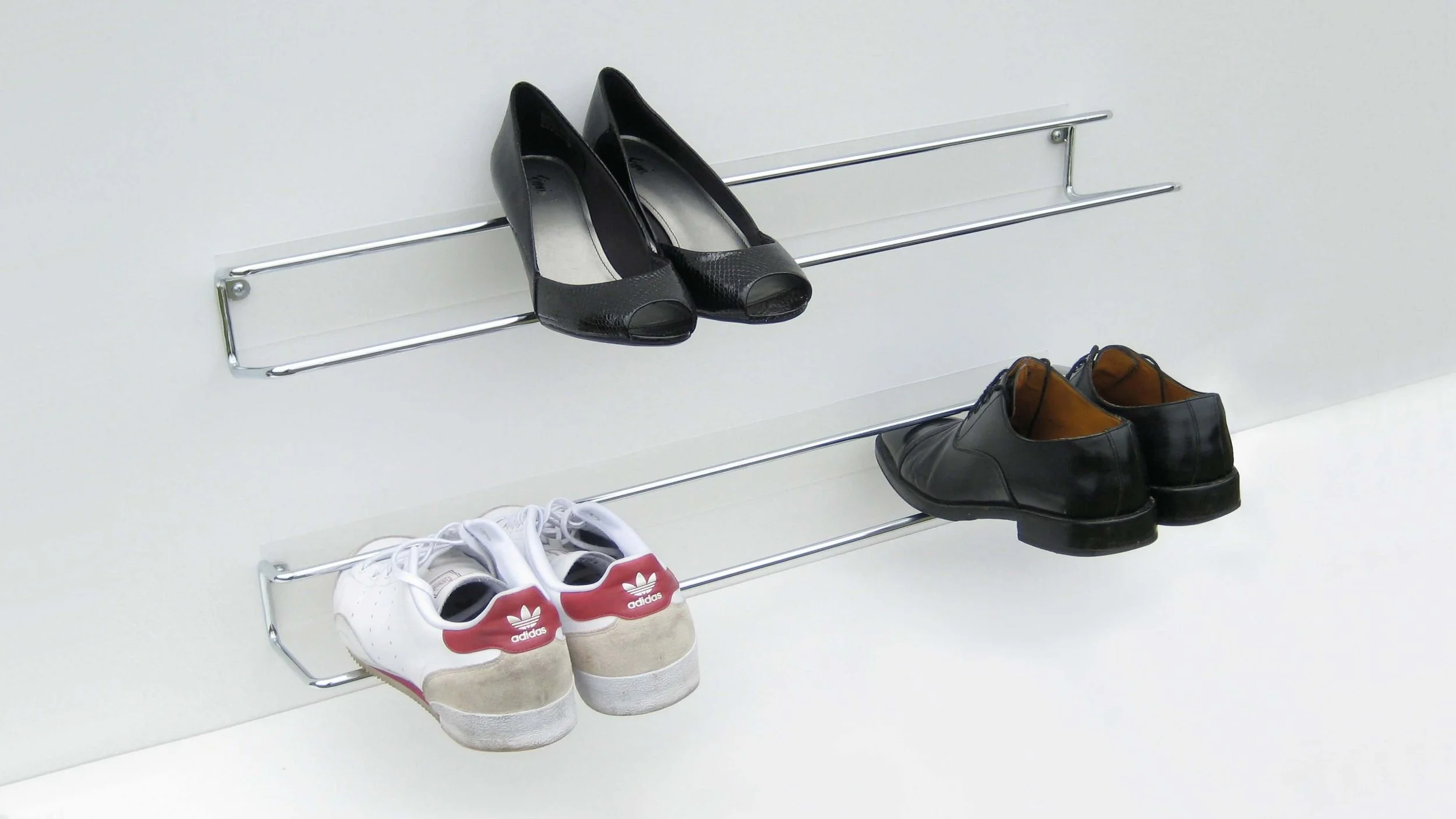Two wall-mounted Wired shoe racks demonstrating how different shoes (with and without heels) can be stored.