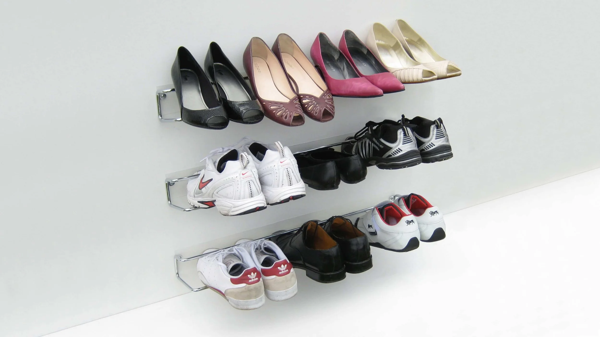 Three Wired shoe racks demonstrating how they can store different shoe types and sizes in a tidy and space efficient way.