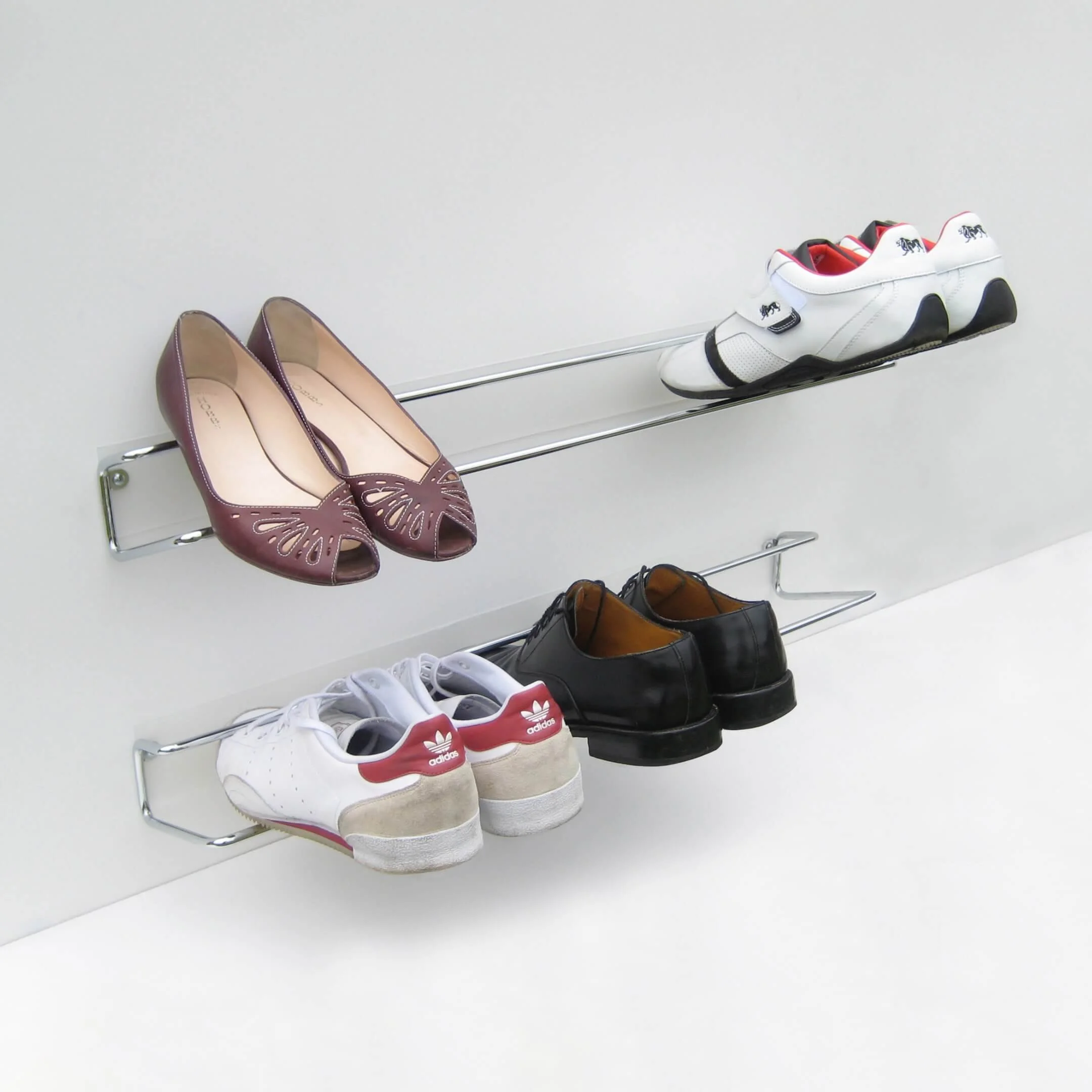 Two Wired shoe racks holding an assortment of shoe types and sizes.