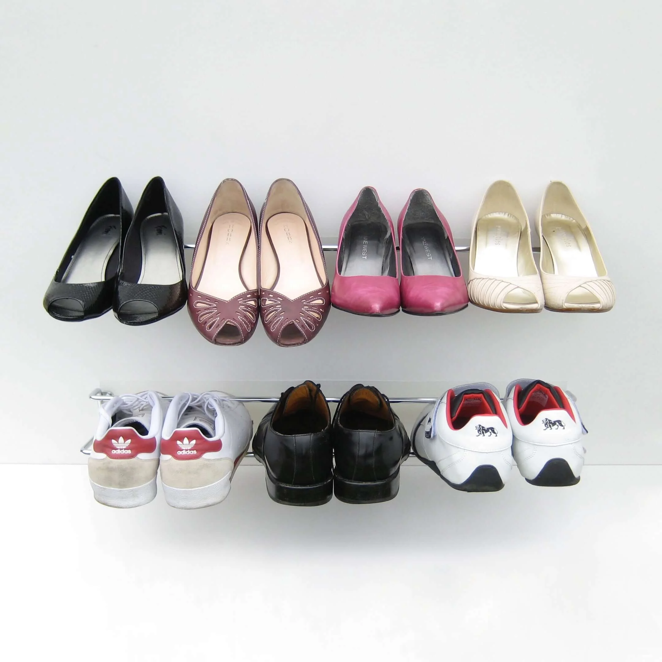 Front view of two Wired shoe racks. One unit holds 4 women's high heel shoes, and the other holds 3 men's shoes.
