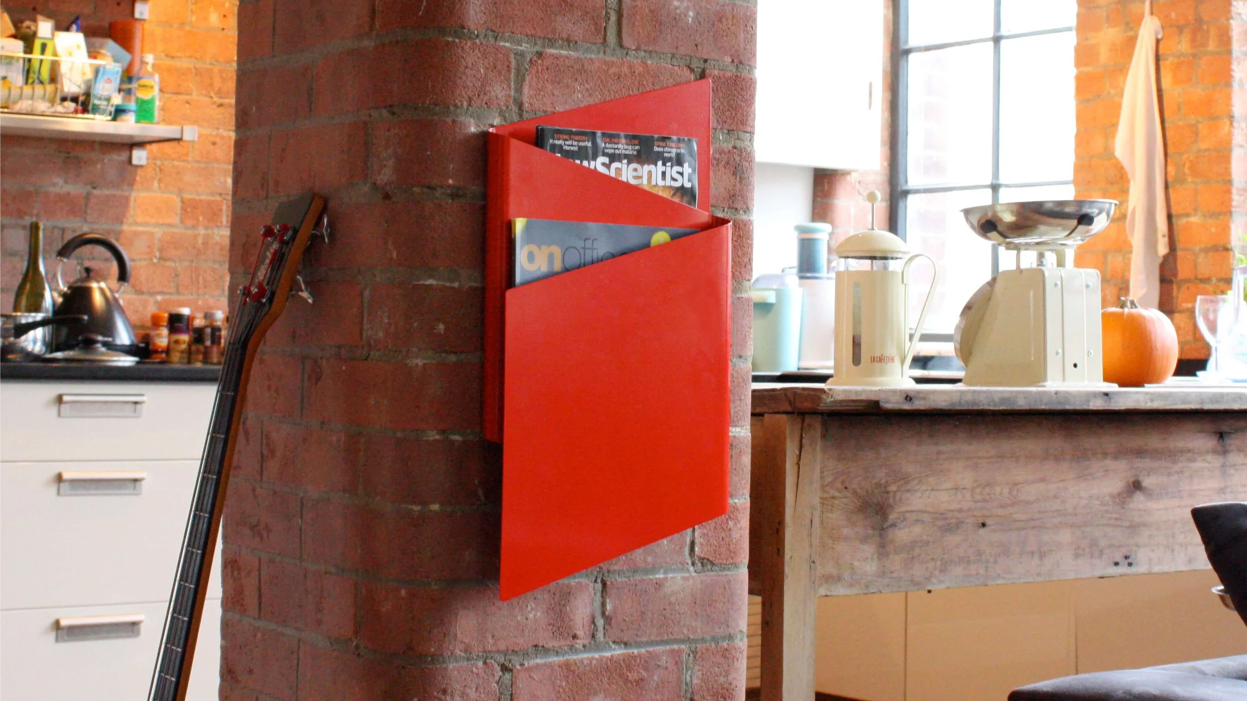 A red Flow magazine rack takes pride of place in a residential interior.