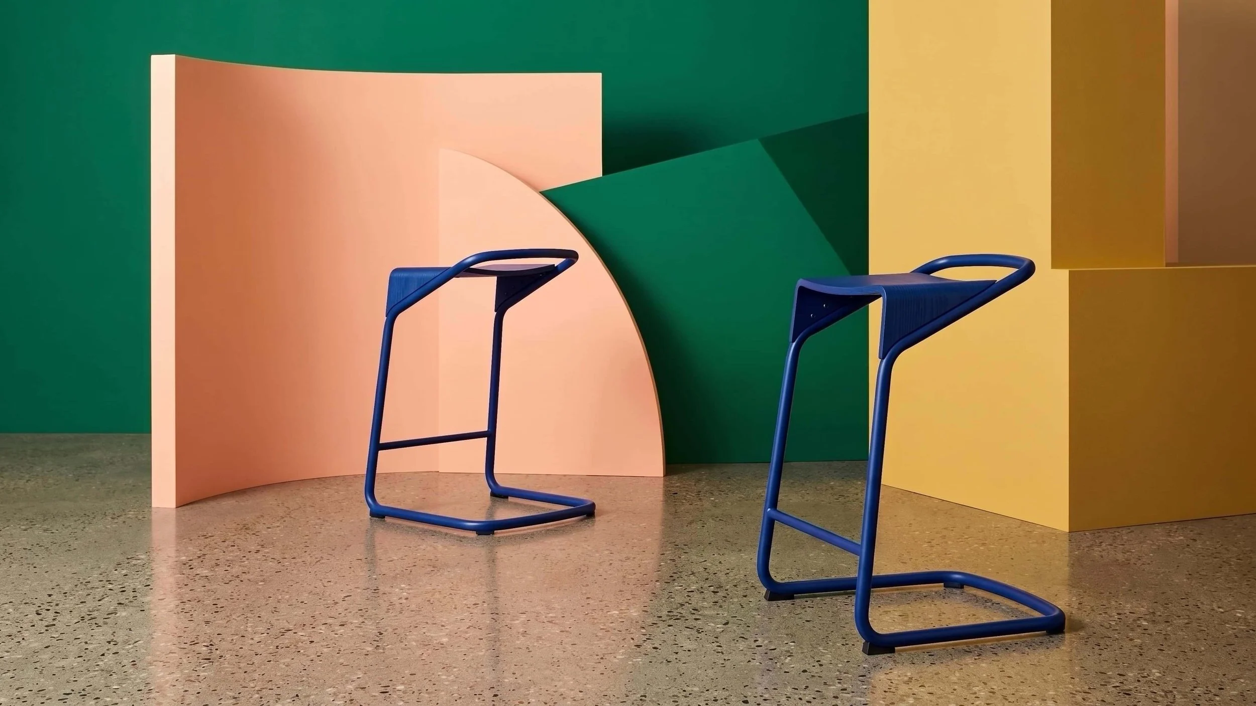 Two Cobalt Blue Camber stools in a stylish photo studio set.