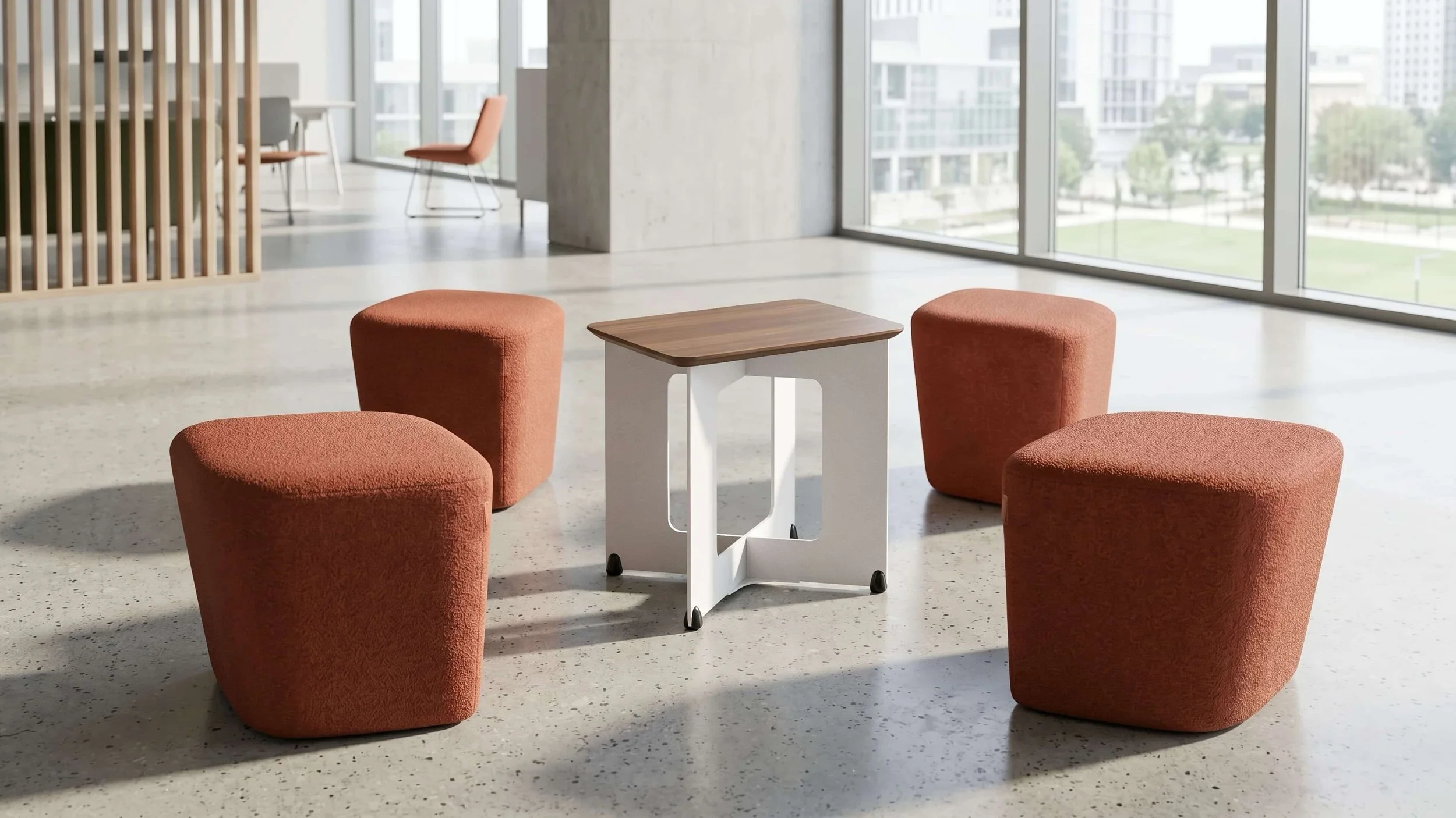 The 4 orange poufs of the Rhombic Seating System are scattered around the central table with a Walnut tabletop.