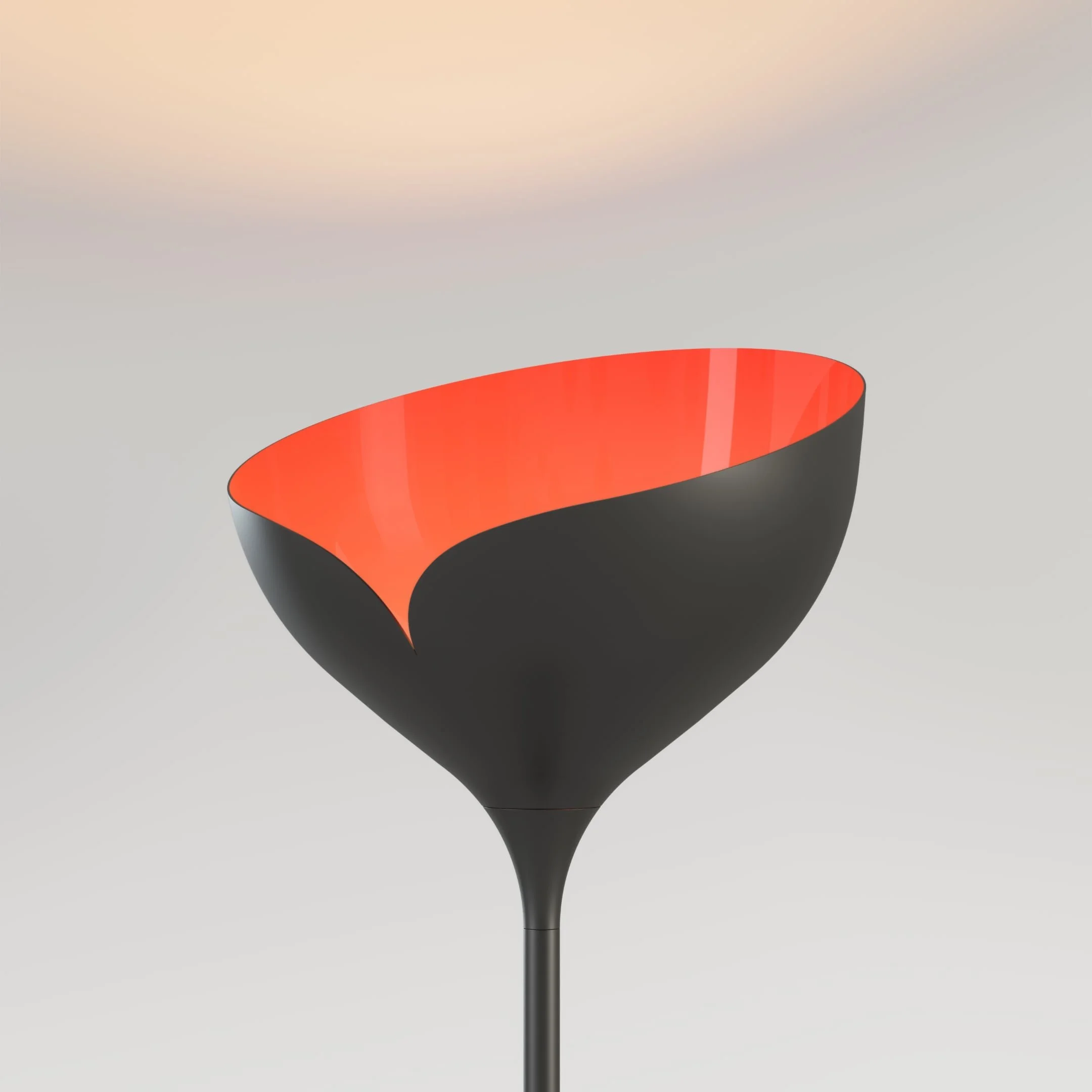 Detail view of a Bloom floor light with a black body and red head. The light is switched on, and the red interior radiates a beautiful, warming glow.