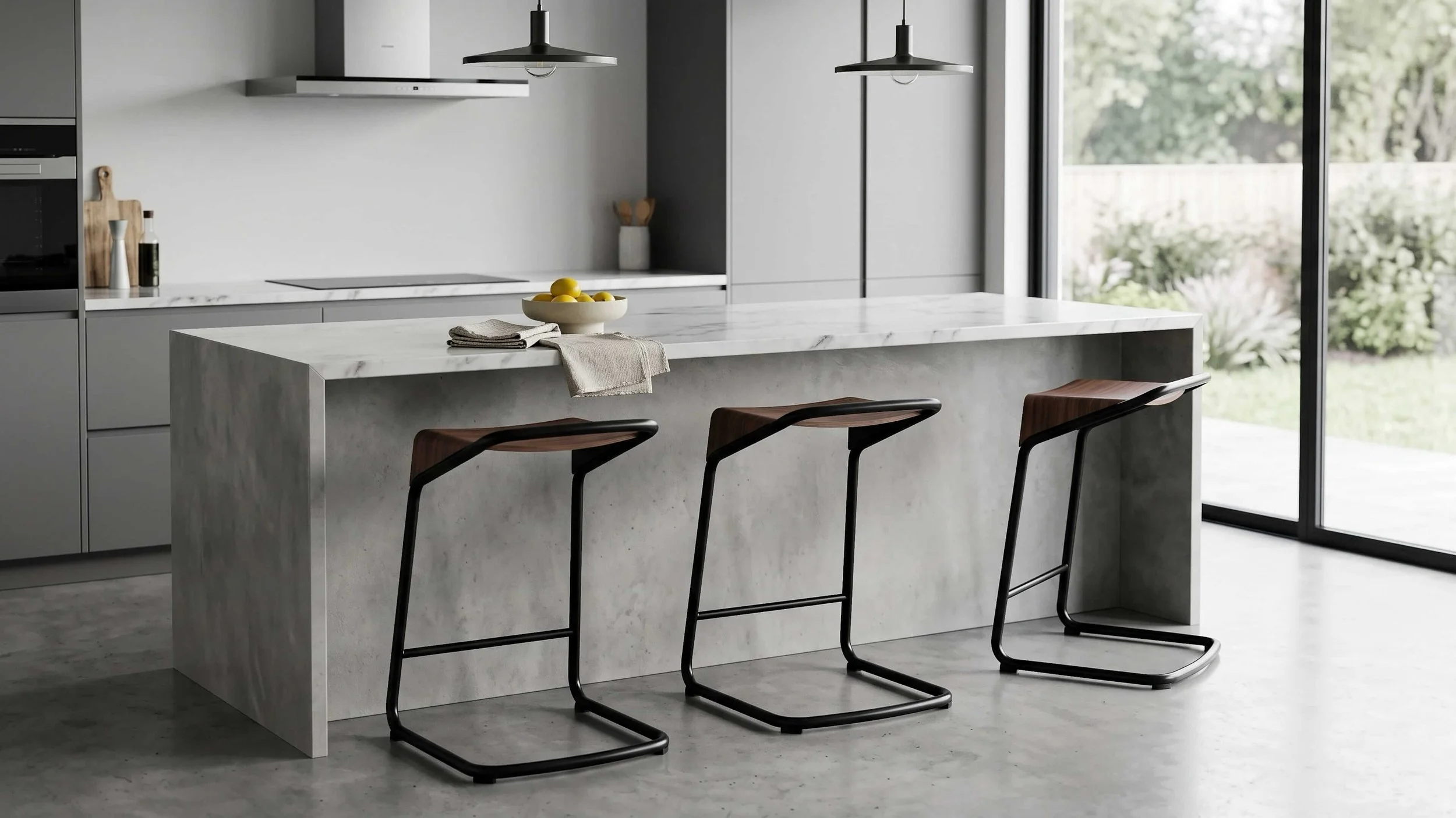 Three Camber stools line up in front of a counter in a modern kitchen.