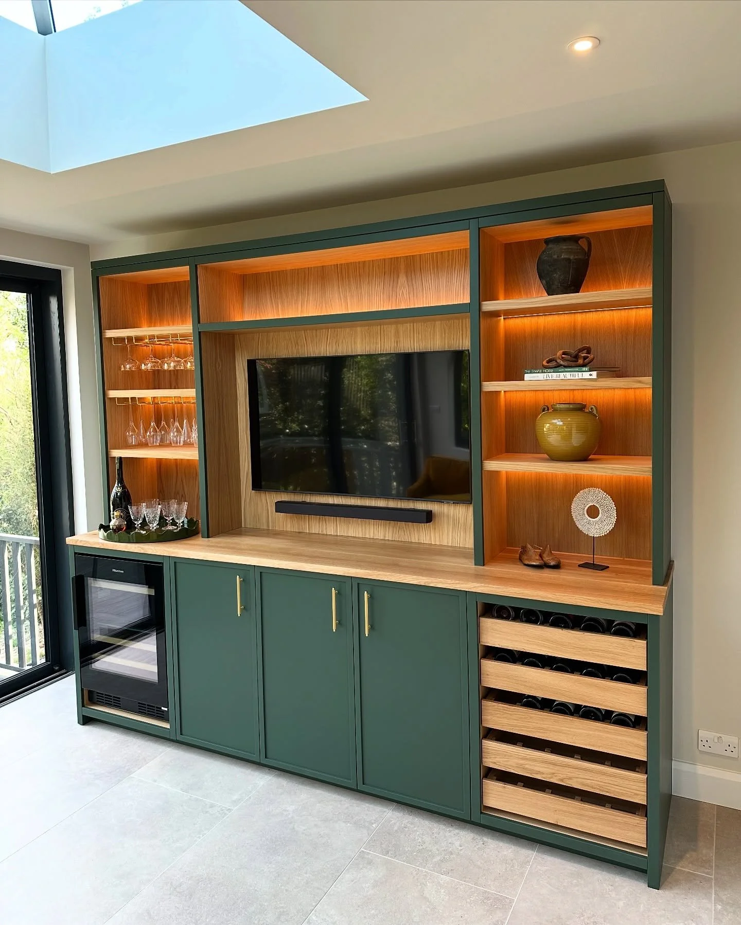 This has been a pleasure to build for some great clients in Guildford . 
Working alongside @emilycocointeriors we created a bespoke media/bar unit with integrated wine fridge and oak pull out red wine storage . 

Sprayed by @emh_decorators in the bea