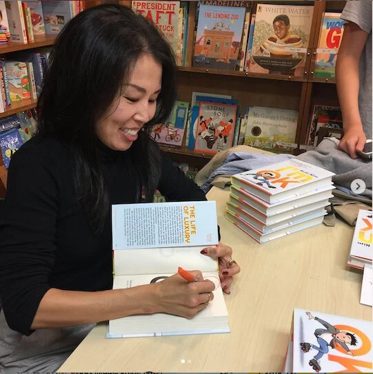Author Patti Kim signing her book I'm OK.