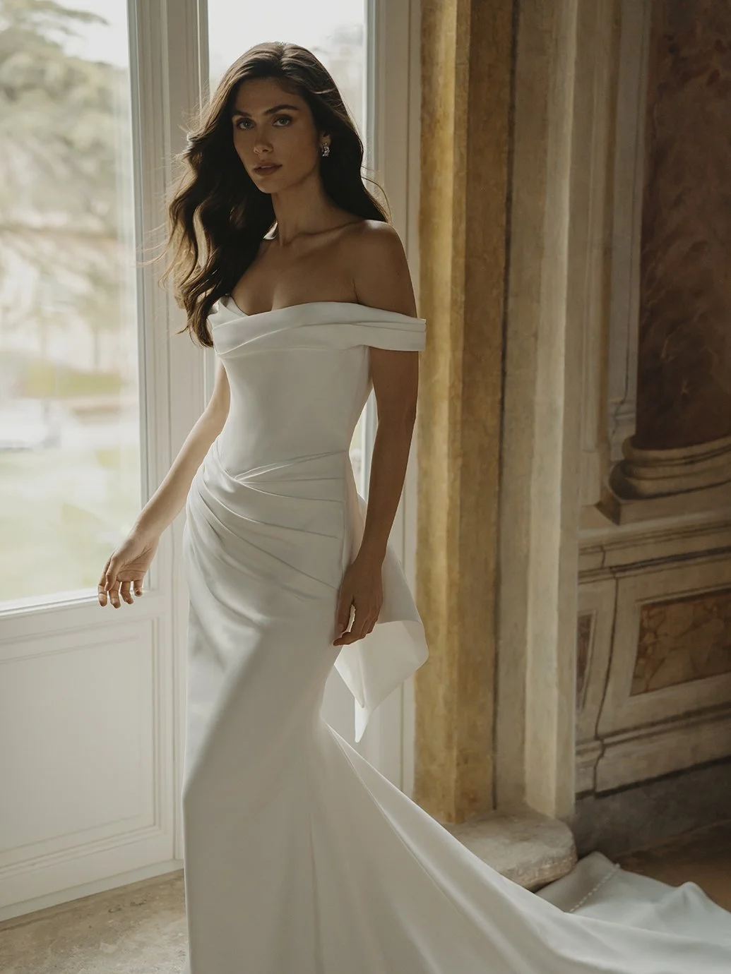 Blue by Enzoani Chicagoland wedding dresses Trisha clean fitted off shoulder bow wedding gown