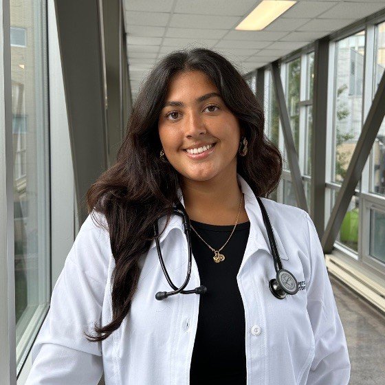 A female medical student wearing a white coat