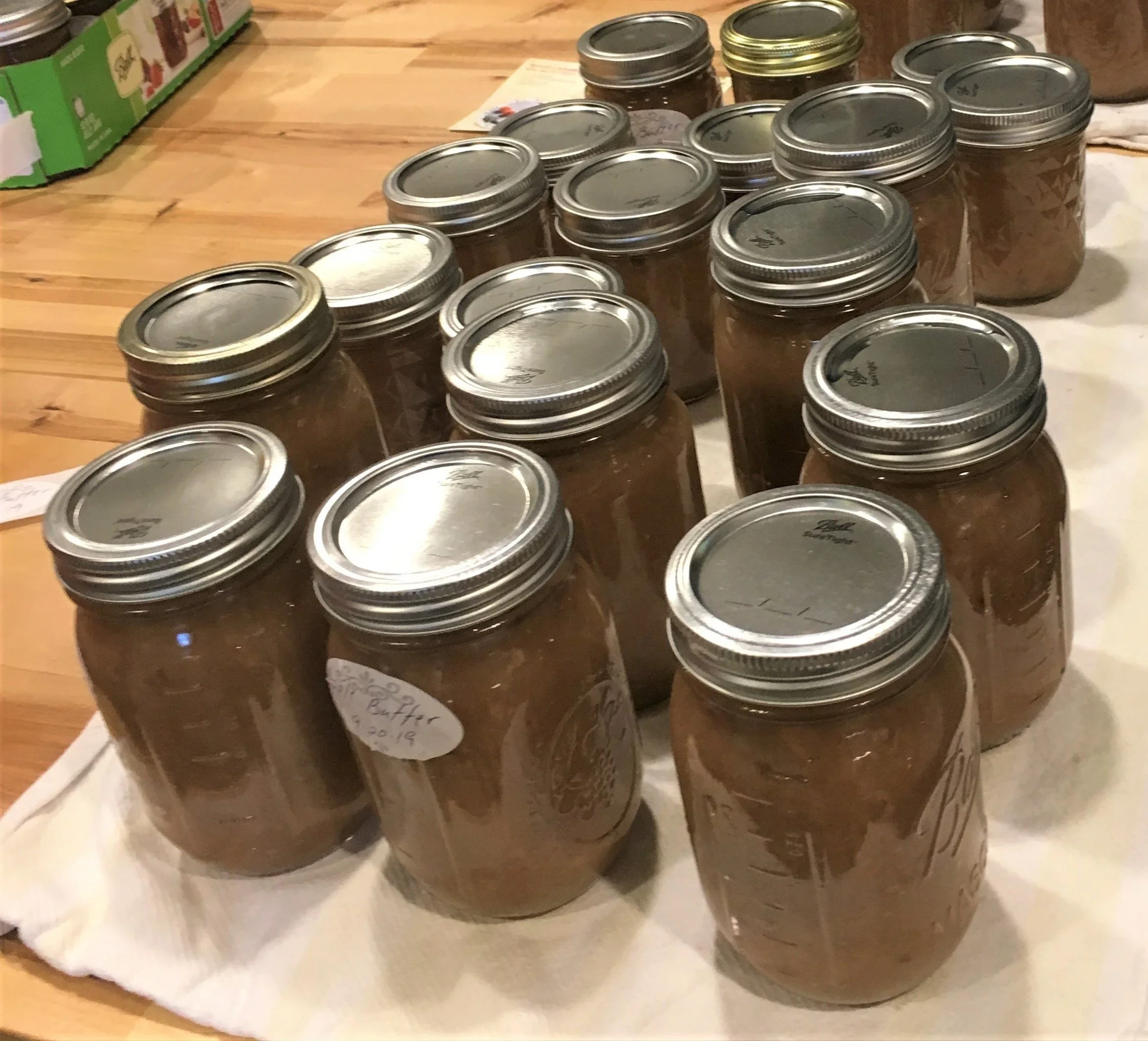 Jars of fresh apple butter sitting on a counter