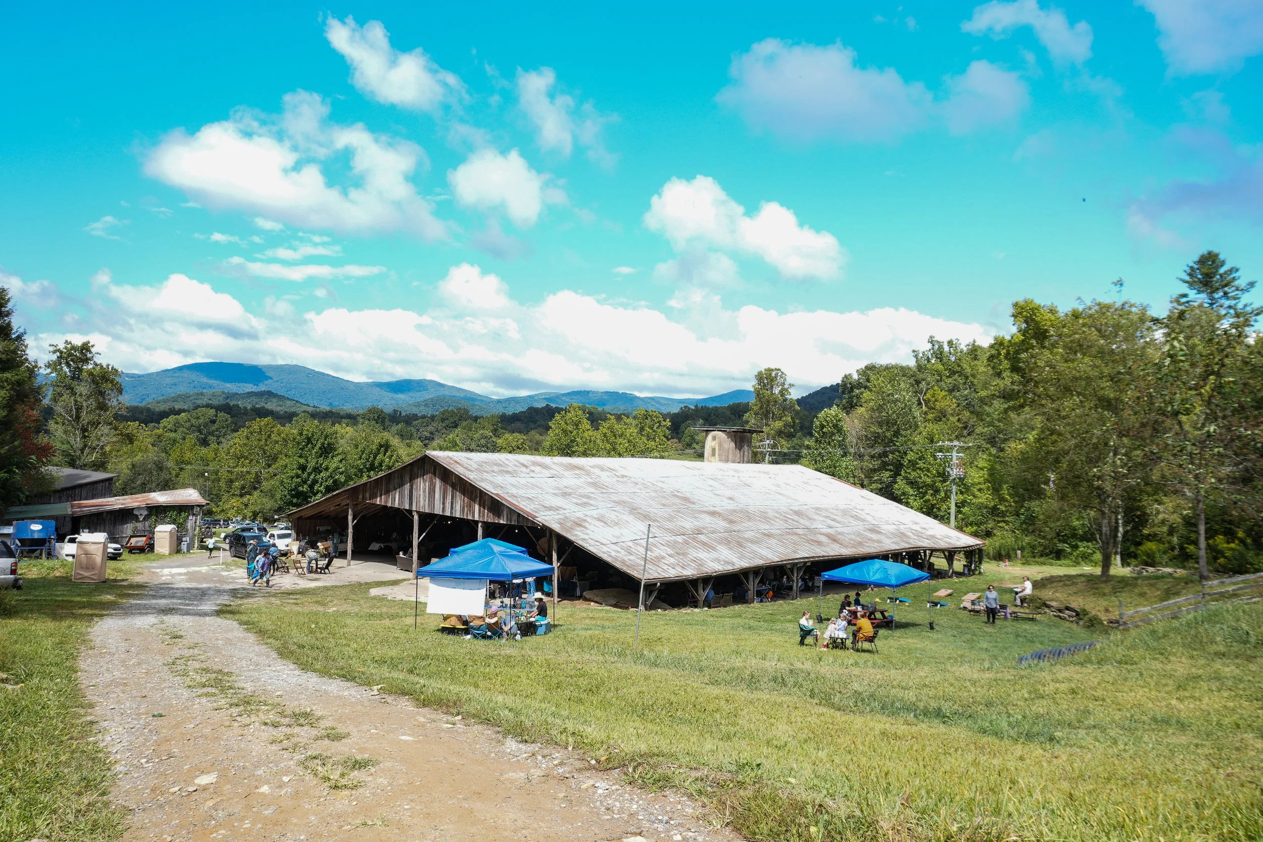 Picture from 2024 Sow & Grow Fest, showing view of Hickory Nut Gap's barn venue where the event was held