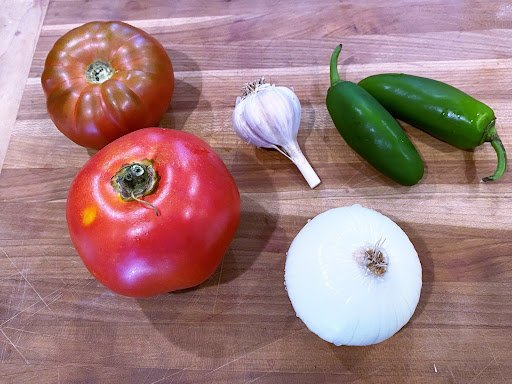 Whole salsa ingredients sitting on a counter