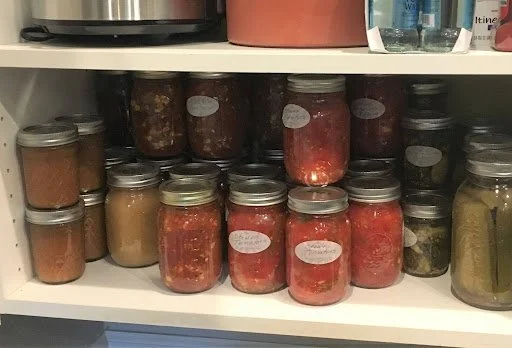Jars of preserved foods on a shelf to store for winter and autumn