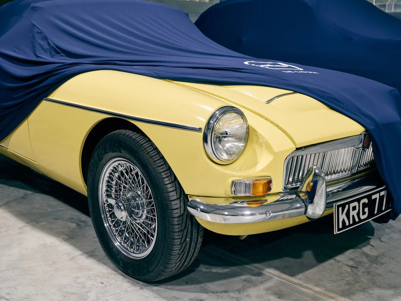 Classic MG under a breathable Car Den cover in Covered Outdoor storage