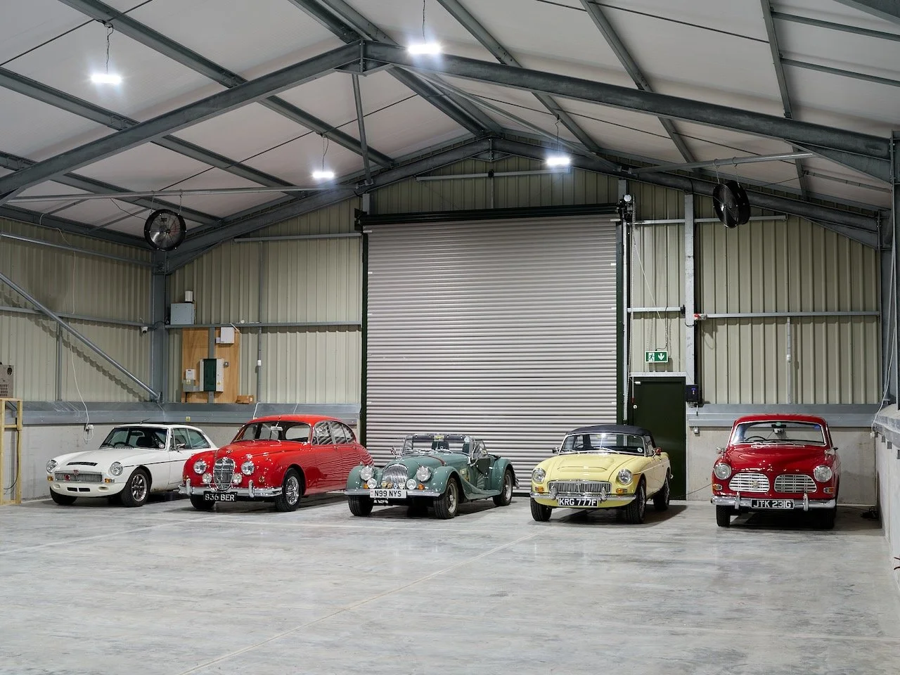 Interior of The Car Den's Premium Indoor facility with five classic cars stored