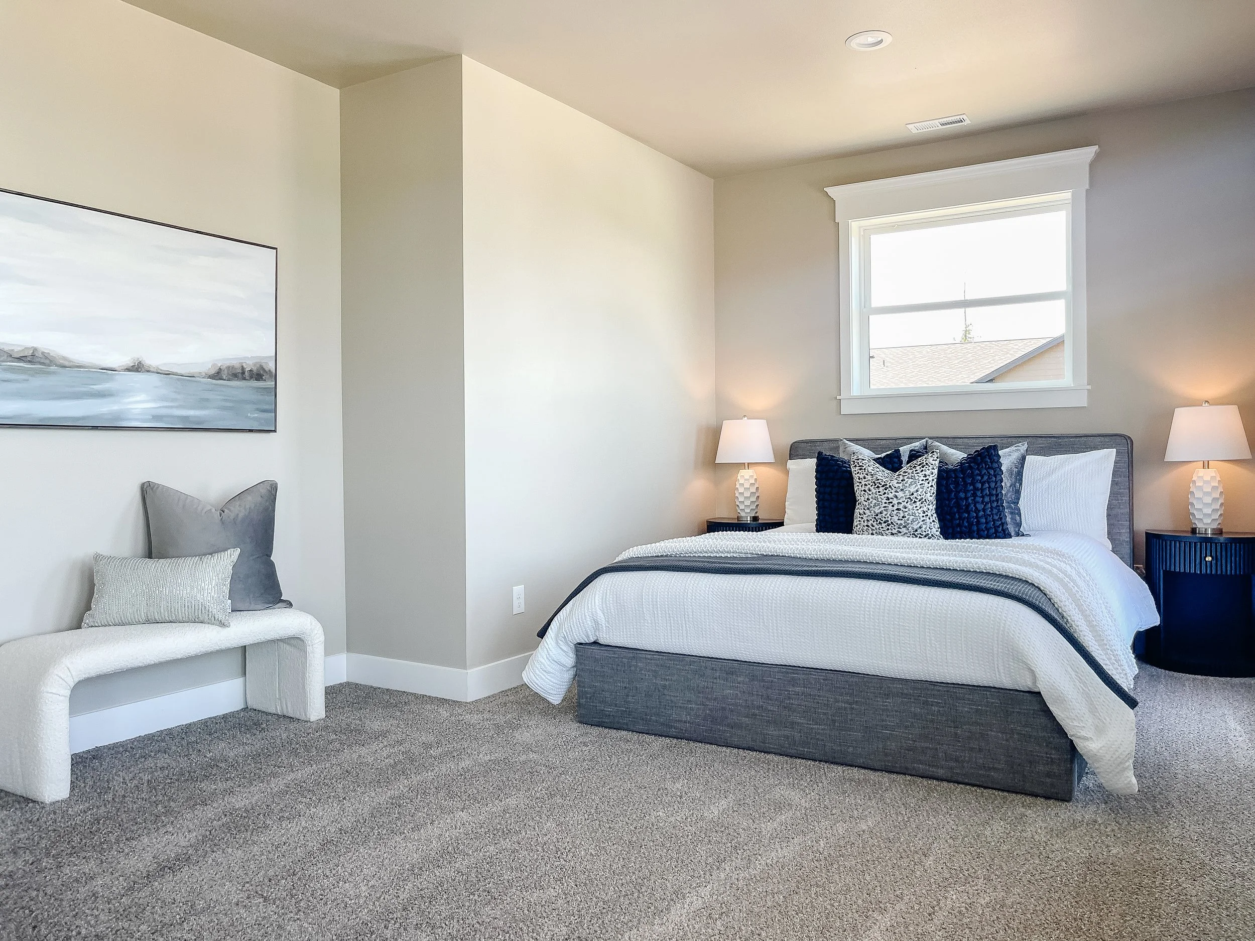 Bedroom in a Friday Harbor home staged to complement natural light and outdoor views.