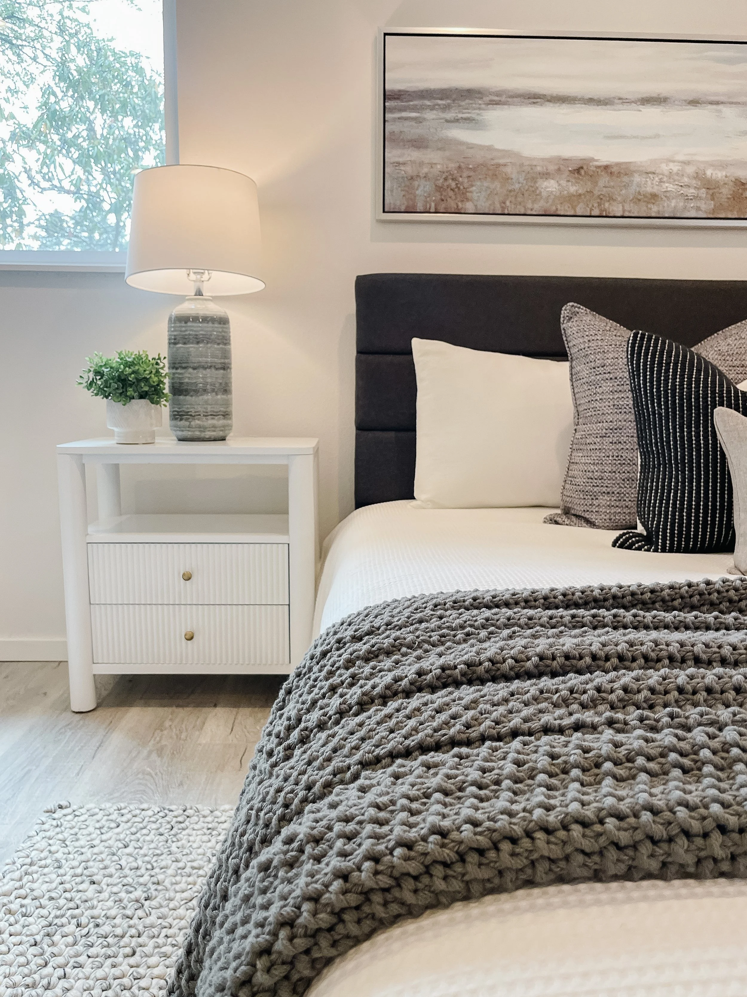 Primary bedroom in Oak Harbor staged with soft textiles to create a calm, inviting feel.