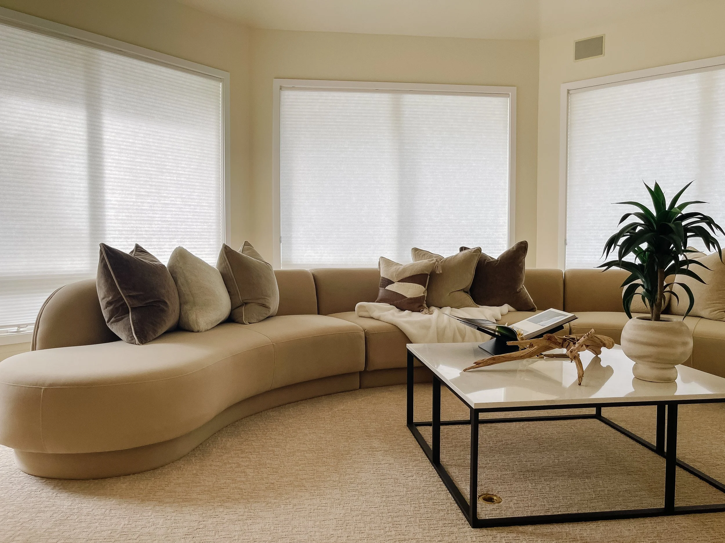 Living space in a Friday Harbor home staged to emphasize natural light and water views.