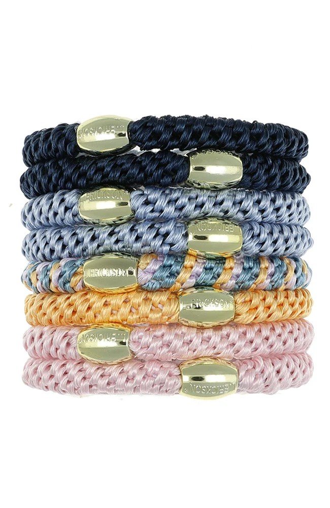 8 ponytail holders ranging in colors from pink, golds, blues and grays.