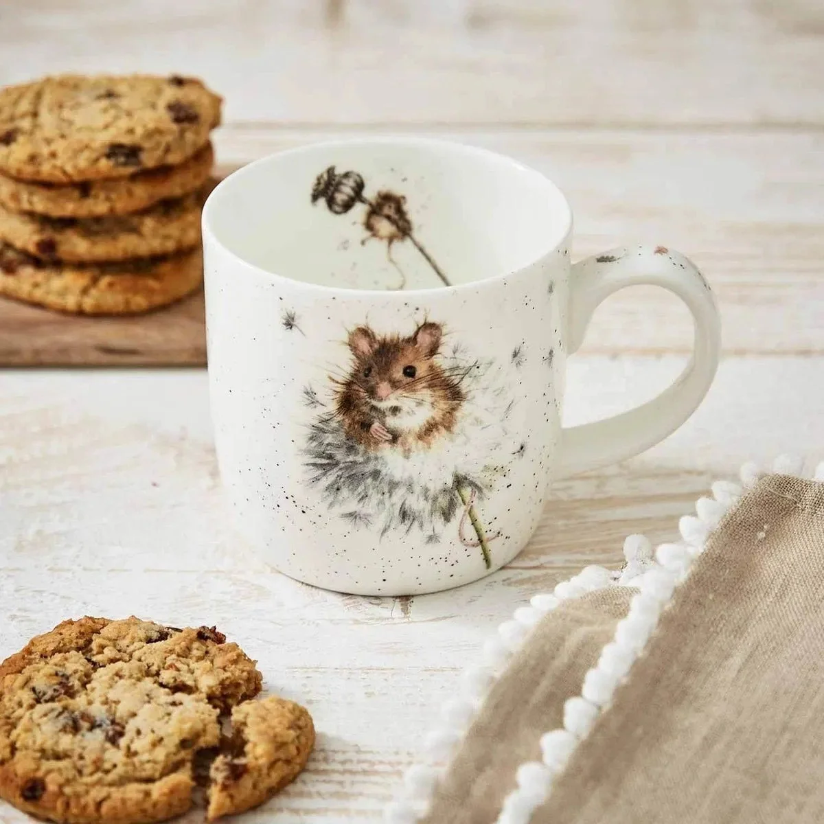 empty mouse mug sitting on table with cookies.