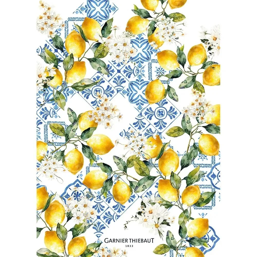 Kitchen towel with blue tile like background and lemon plants in the foreground.