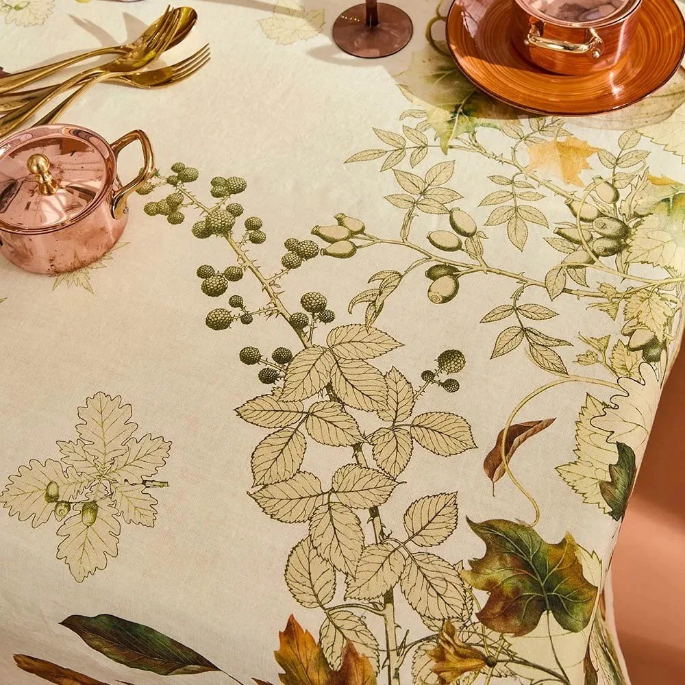 close-up view of cream vintage inspired tablecloth showcasing fall vines.