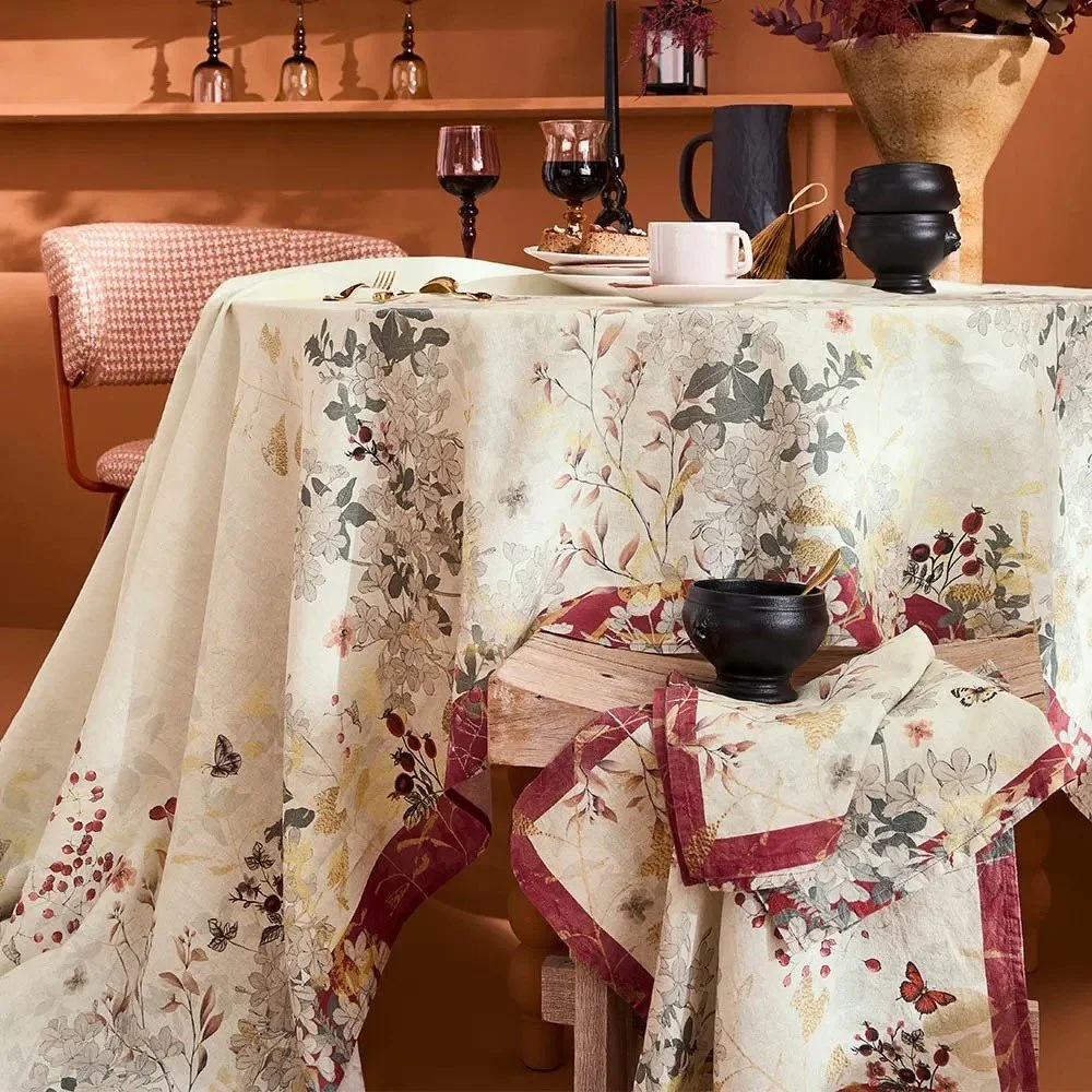 Cream tablecloth with floral and cranberry print.