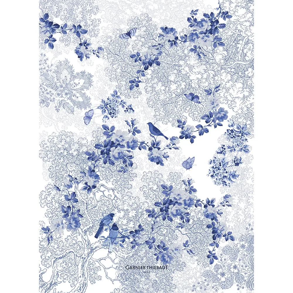 blue and white kitchen towel featuring floral leaves, birds and butterflies.