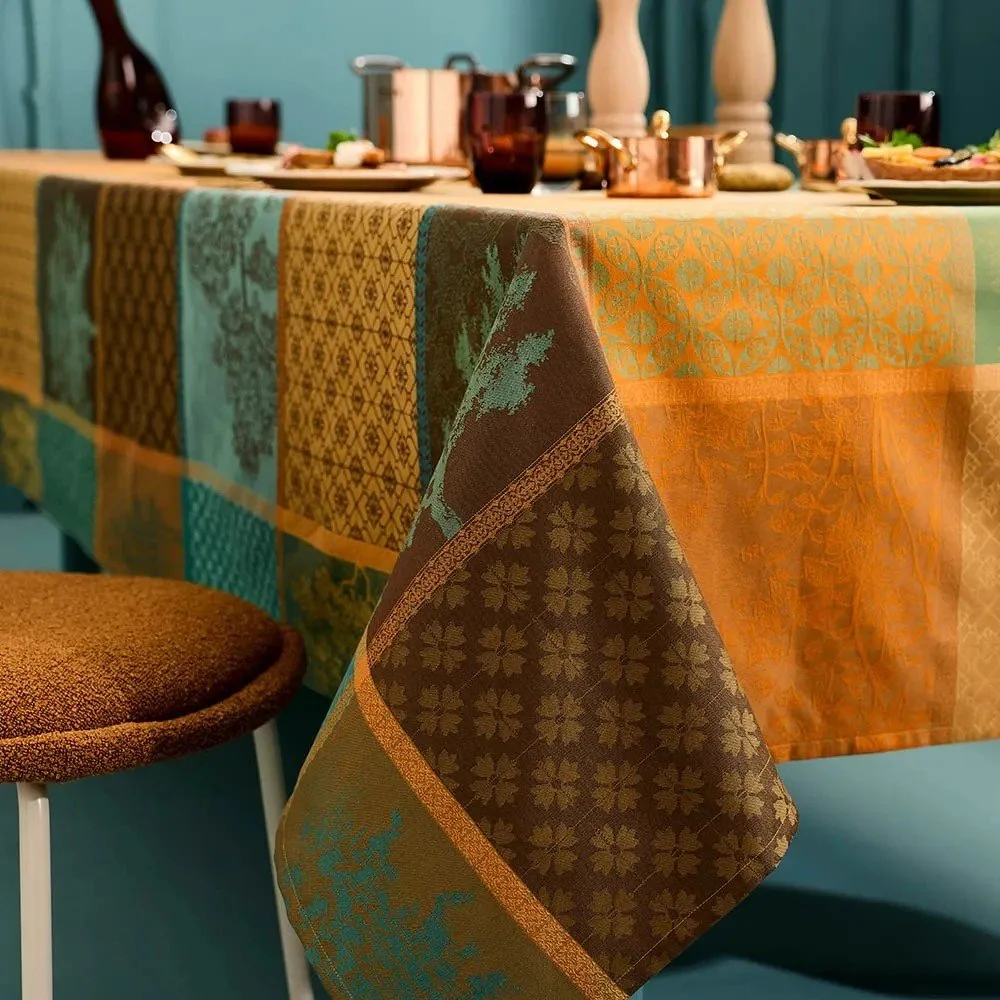 jacquard tablecloth set with food and decor.