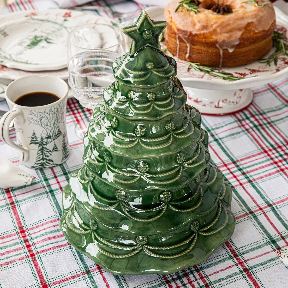 Closed Christmas tree cookie jar on set table.