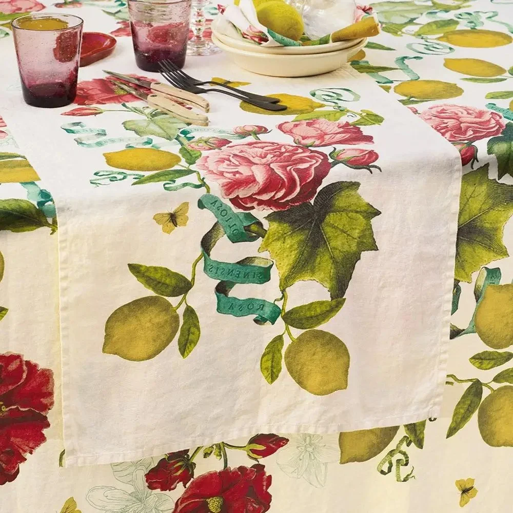 lemon and pink floral table runner sitting on matching tablecloth.