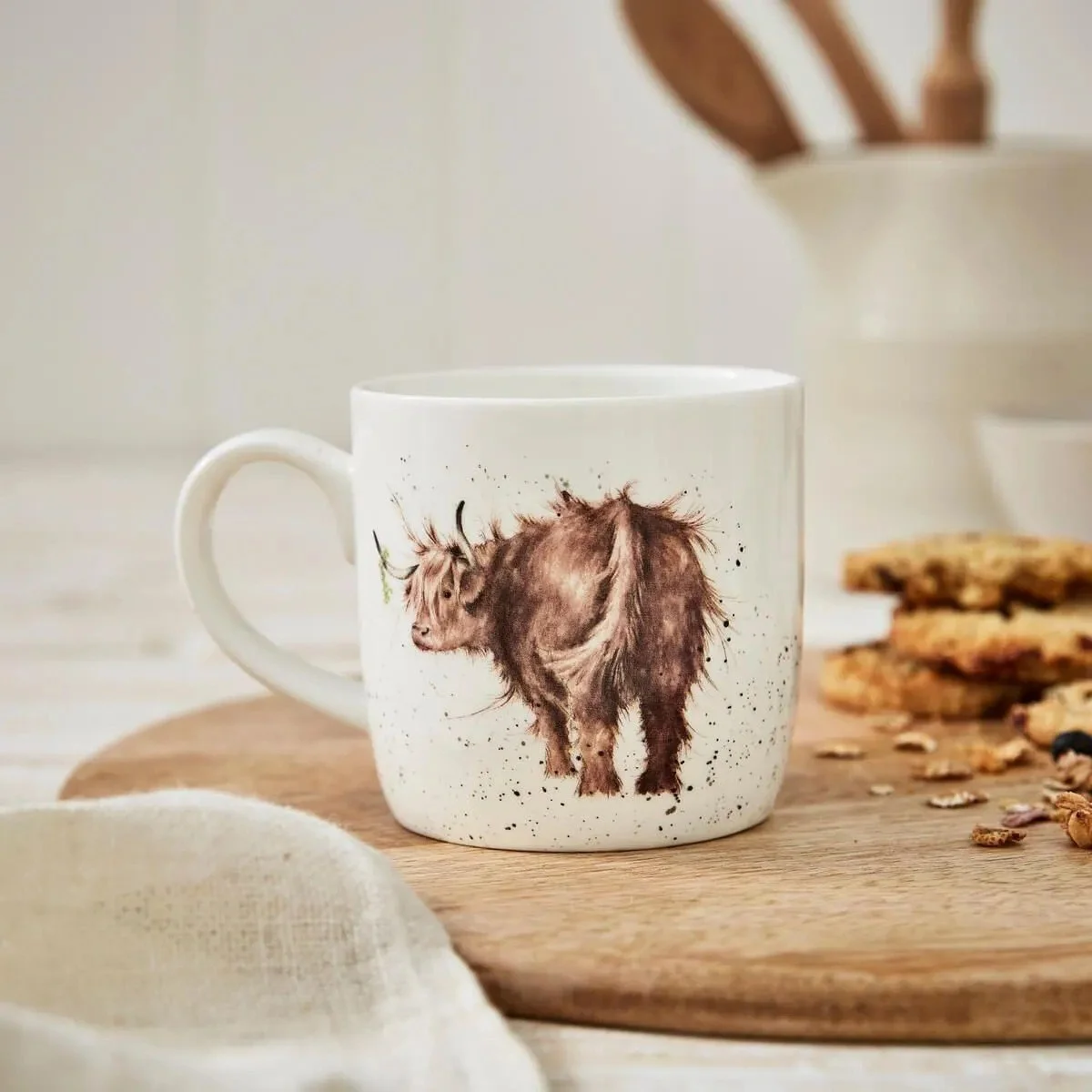 white mug with brown highland cow looking over his left shoulder.