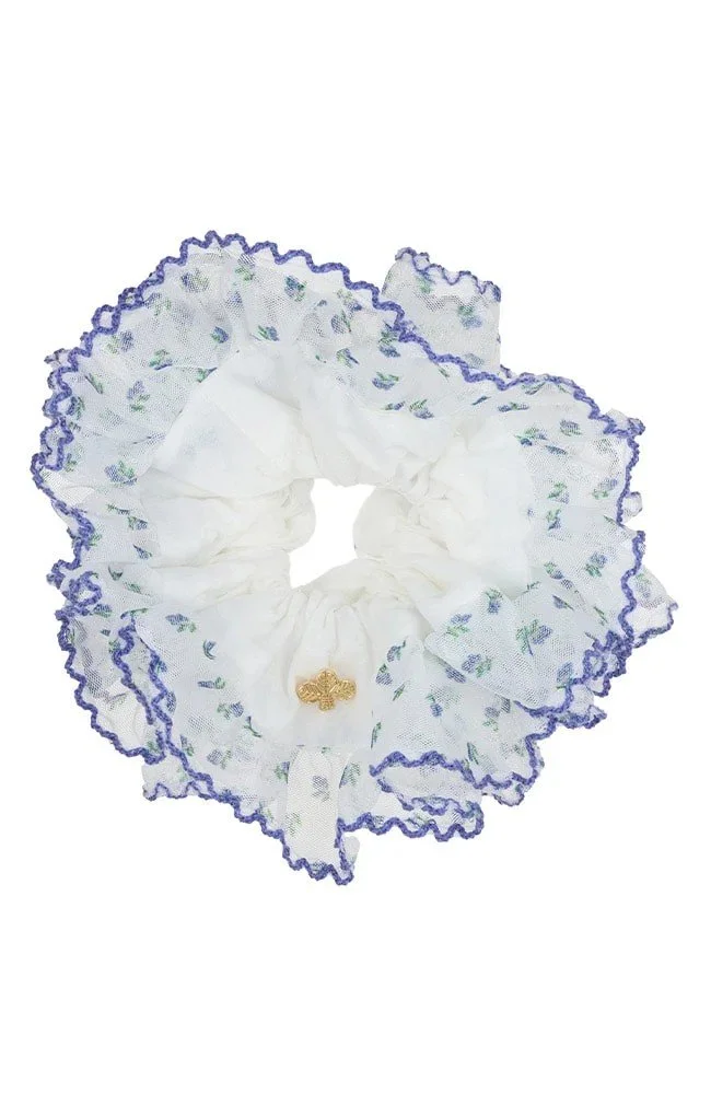 White hair scrunchies with delicate blue trim and green print.