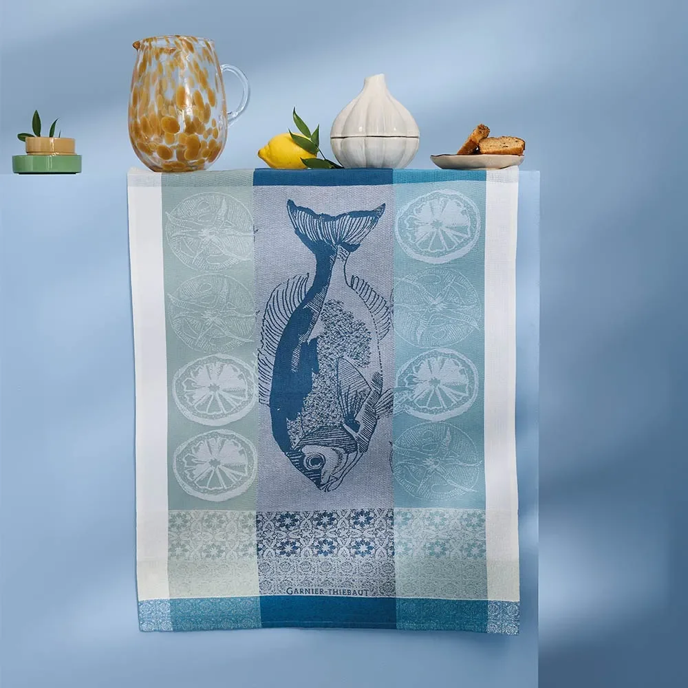 Plancha Outremer kitchen towel hanging over side being held up by vases.