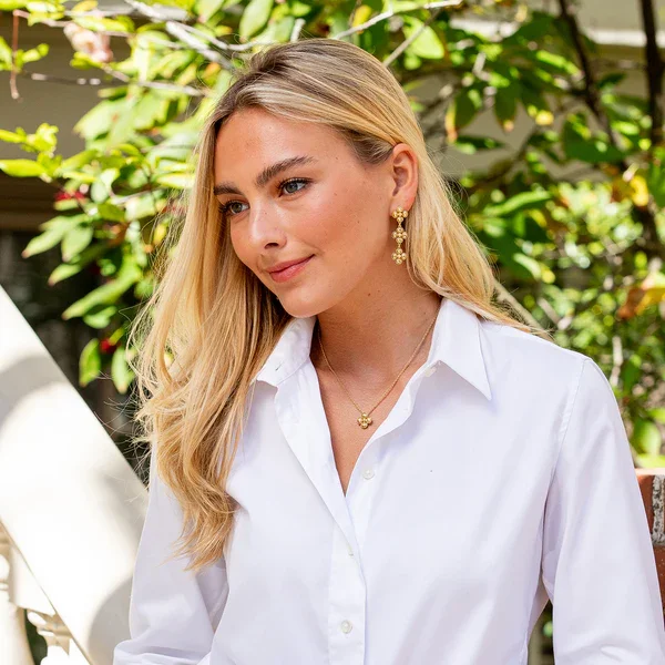 Woman in white button-down waring Berry Clover Station Necklace.