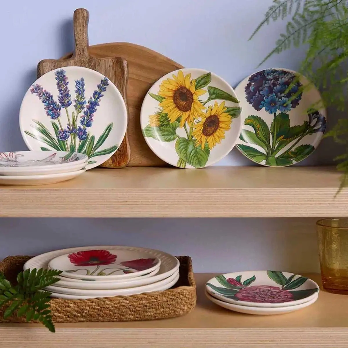 Floral side plates on shelf with other items.
