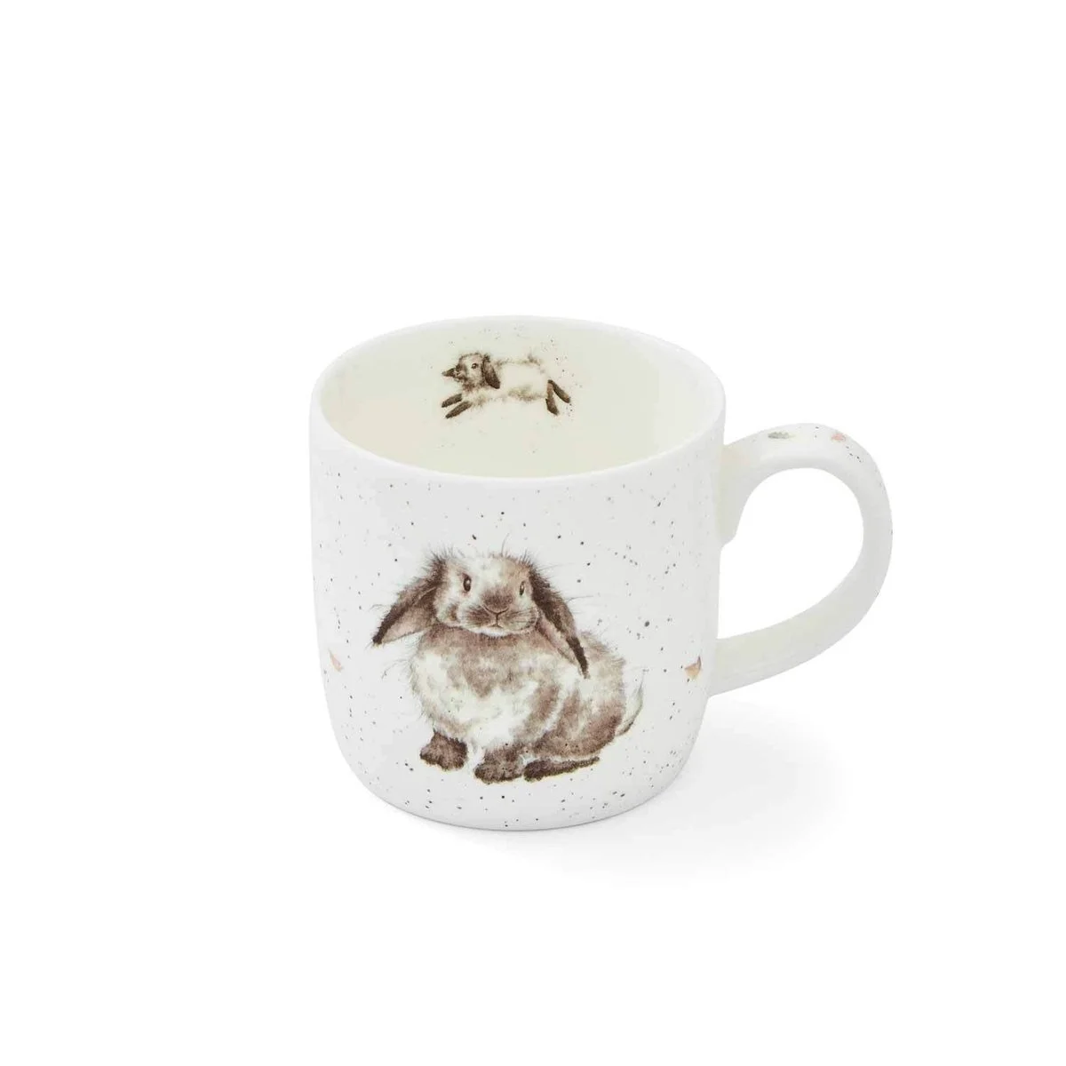 White mug with black specks and fluffy rabbit sitting on outside and inside the rabbit is jumping away.