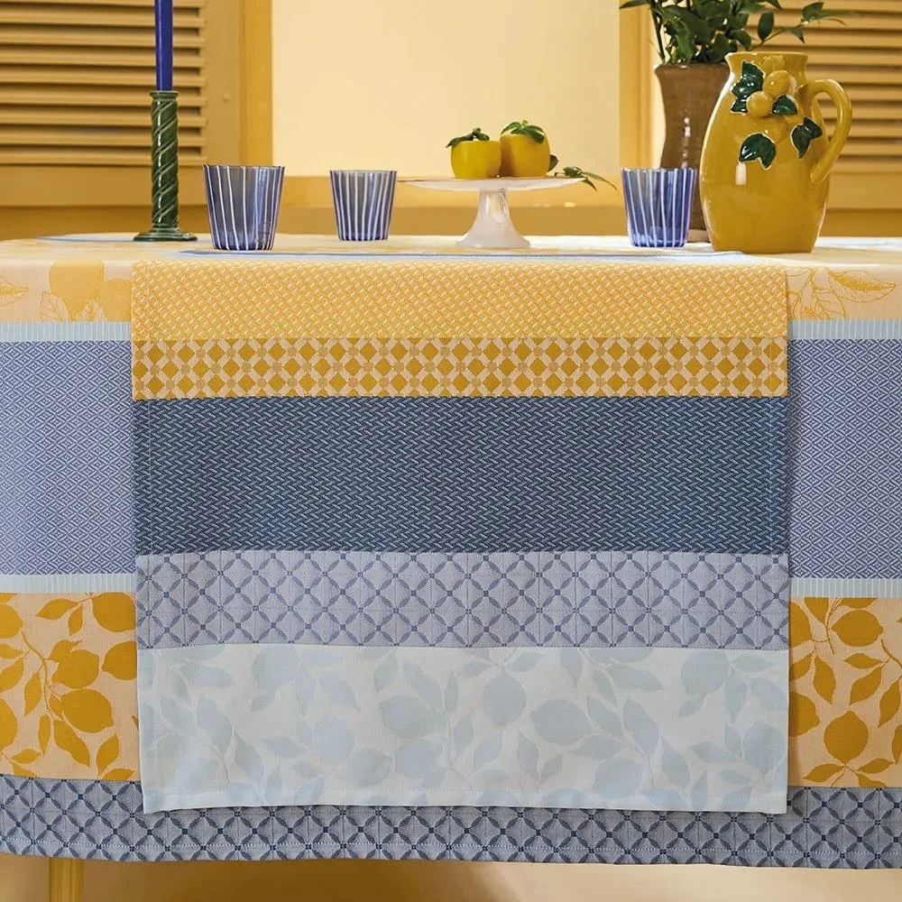 yellow and blue table runner setting a top a table with a matching tablecloth.